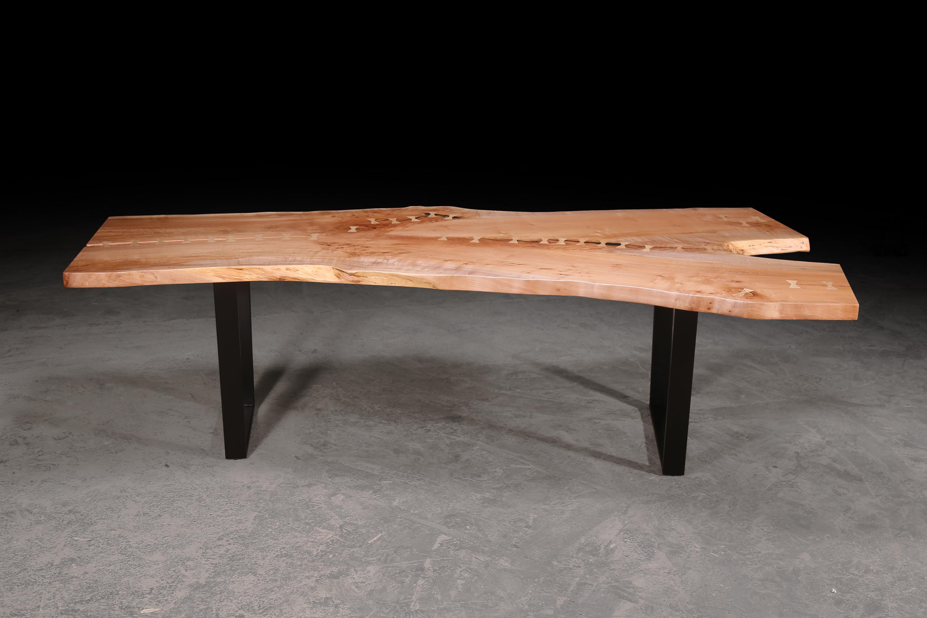 This single maple slab table is made from reclaimed wood from trees that have fallen naturally due to storm, disease or insect damage. Trees grow tall in the Pacific Northwest, and this specific slab came from Oregon. This table can be used as a