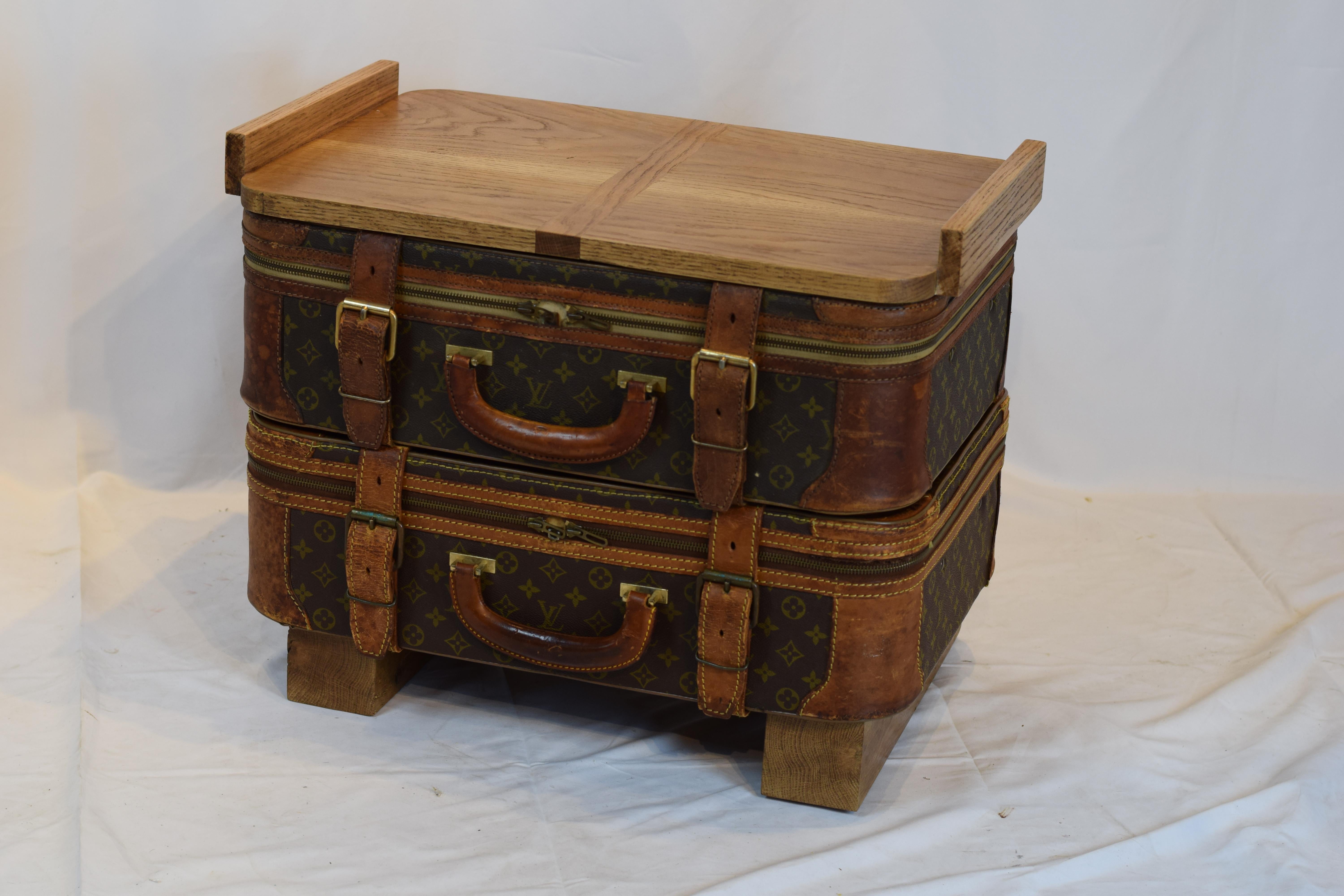 This Louis Vuitton luggage table is a custom creation. Two vintage Louis Vuitton luggage pieces using an oak platform for the feet and topped with a beautiful multi functional tray. The luggage itself is in very nice condition and has not been