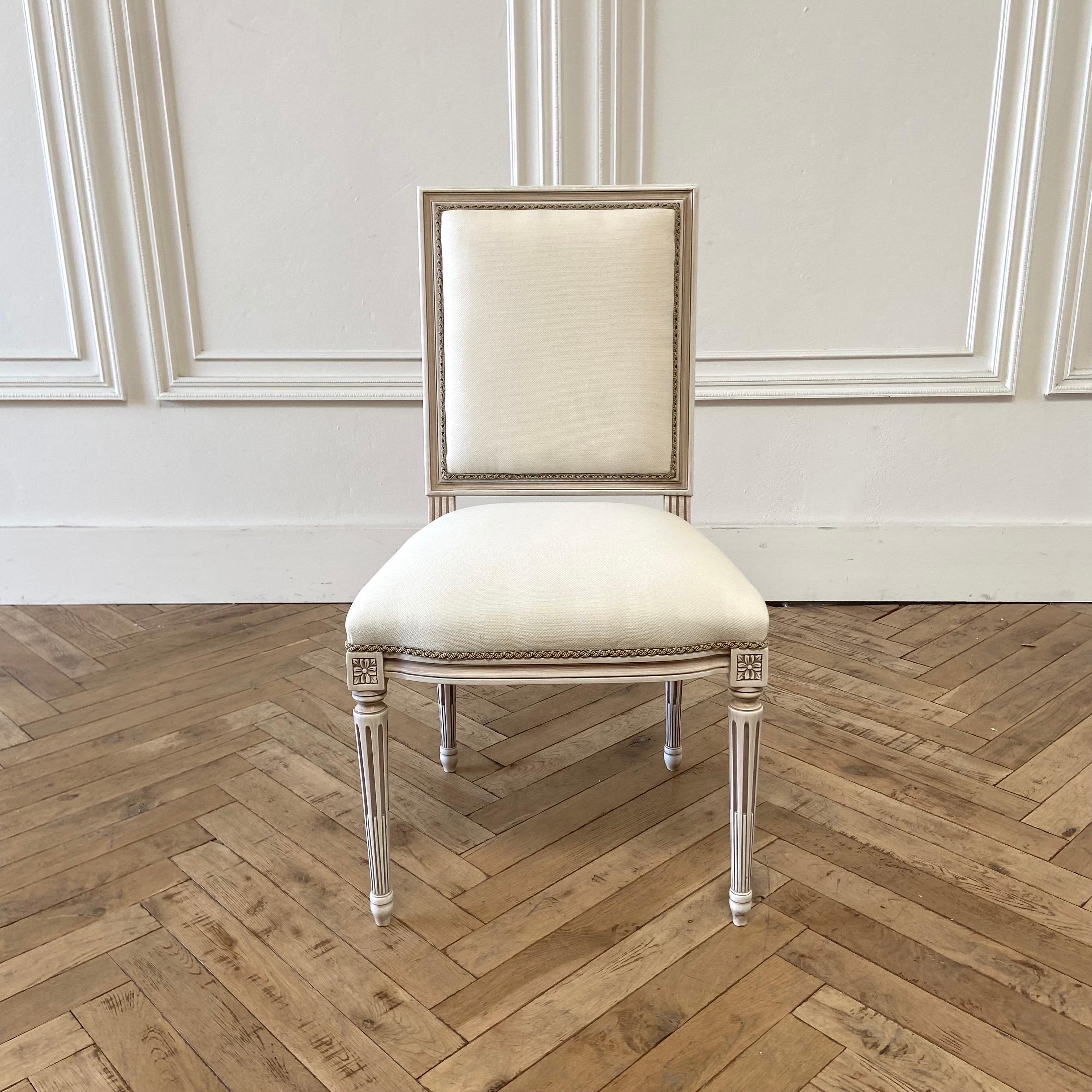 Louis XVI style dining chairs 
Painted in a French Oyster Finish with subtle distressed and glazed patina.
Made from solid european beech wood, and upholstered in an off white linen blend and antique braided trim. Very solid and sturdy. Can be