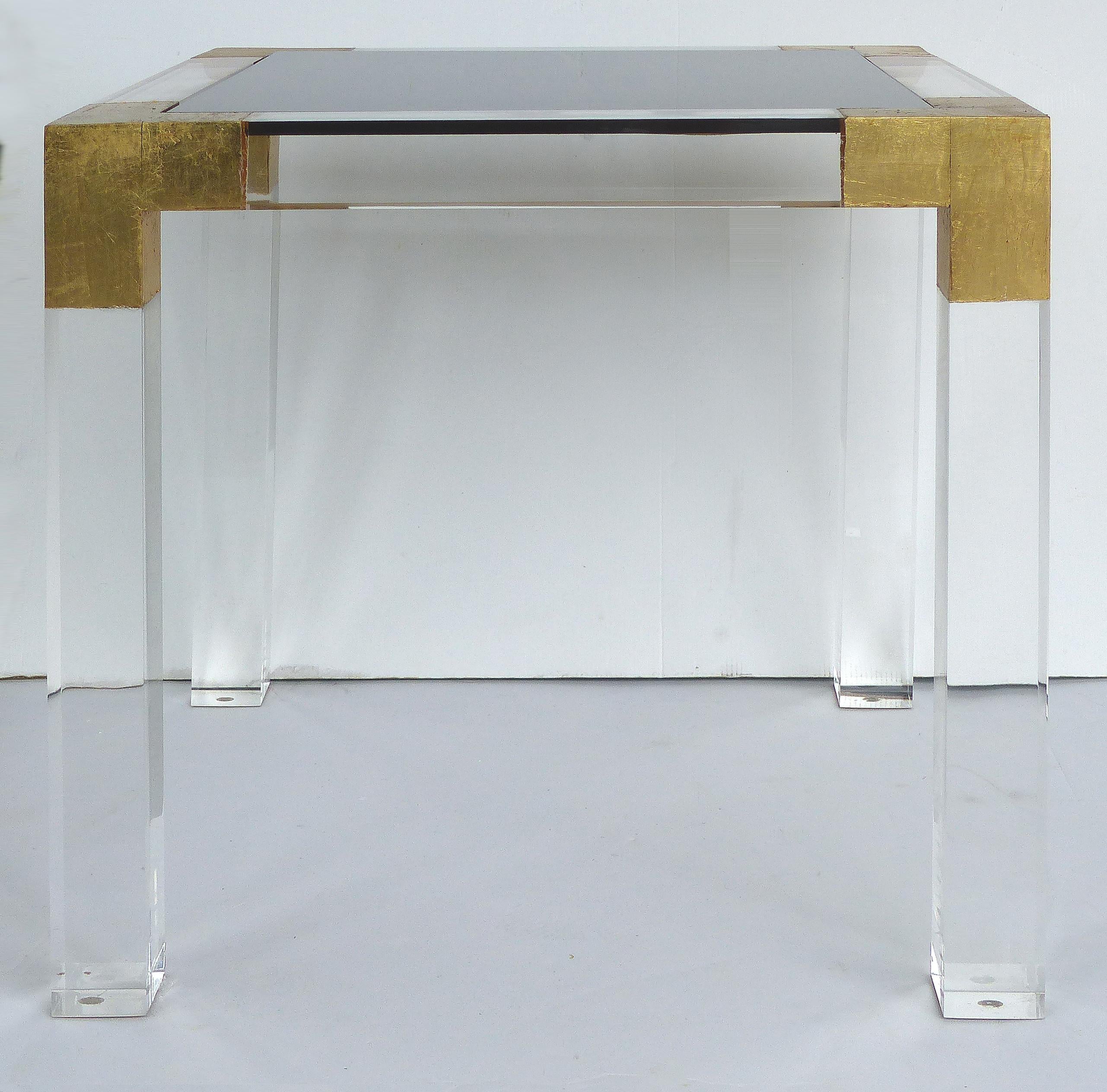 Custom Lucite Side Table with Interchangeable Tops and Gold Leaf Accents

Offered for sale is a custom-made side table made of thick Lucite having gold leaf accents on the corners and interchangeable tops; one in black Lucite, the second in clear