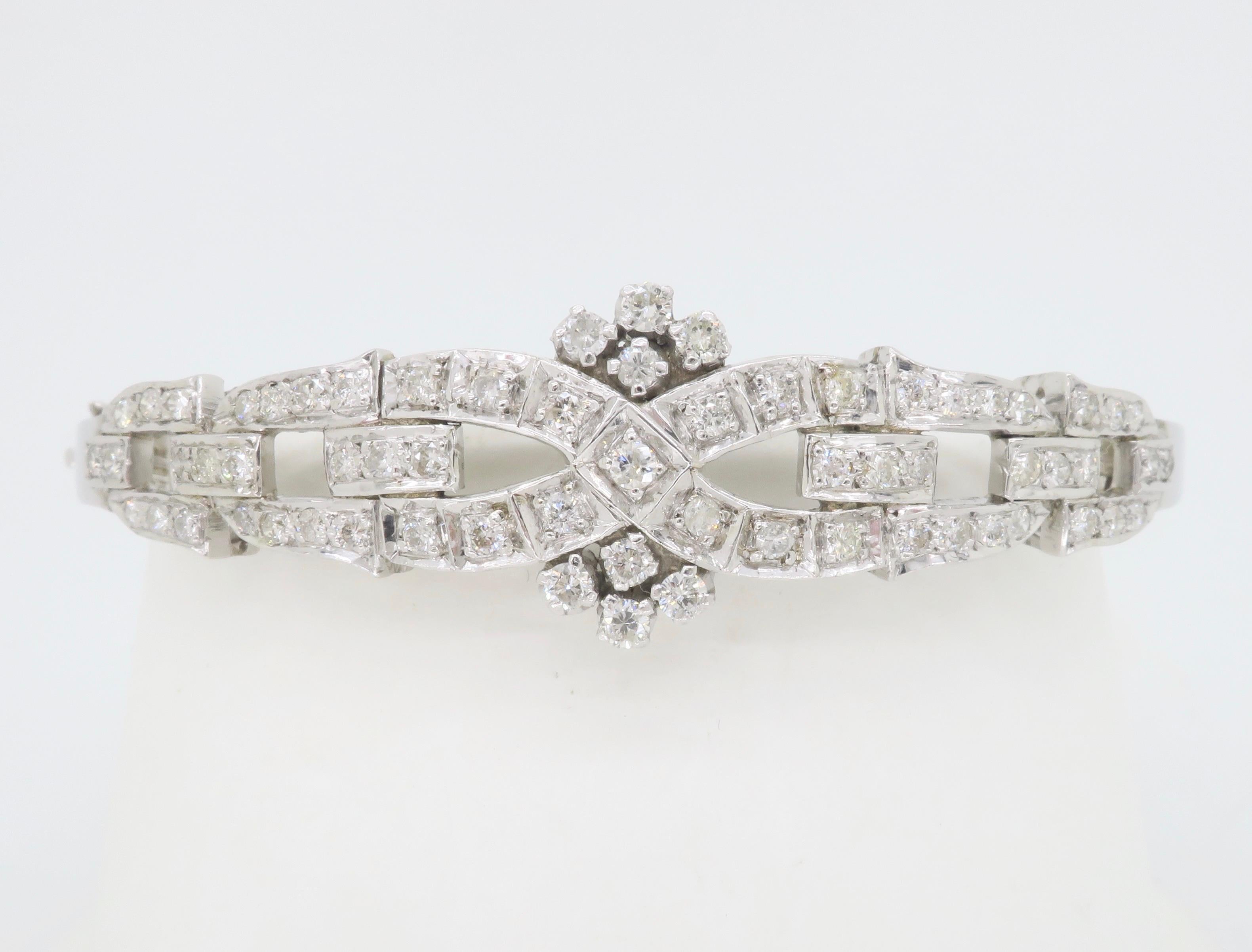 Stunning custom made diamond bangle bracelet featuring 1.60CTW of diamonds. 

Gemstone: Diamond
Diamond Carat Weight: Approximately 1.60CTW
Diamond Cut: Round Brilliant Cut
Average Diamond Color: F-H
Average Diamond Clarity: SI-I
Metal: 90% Silver,