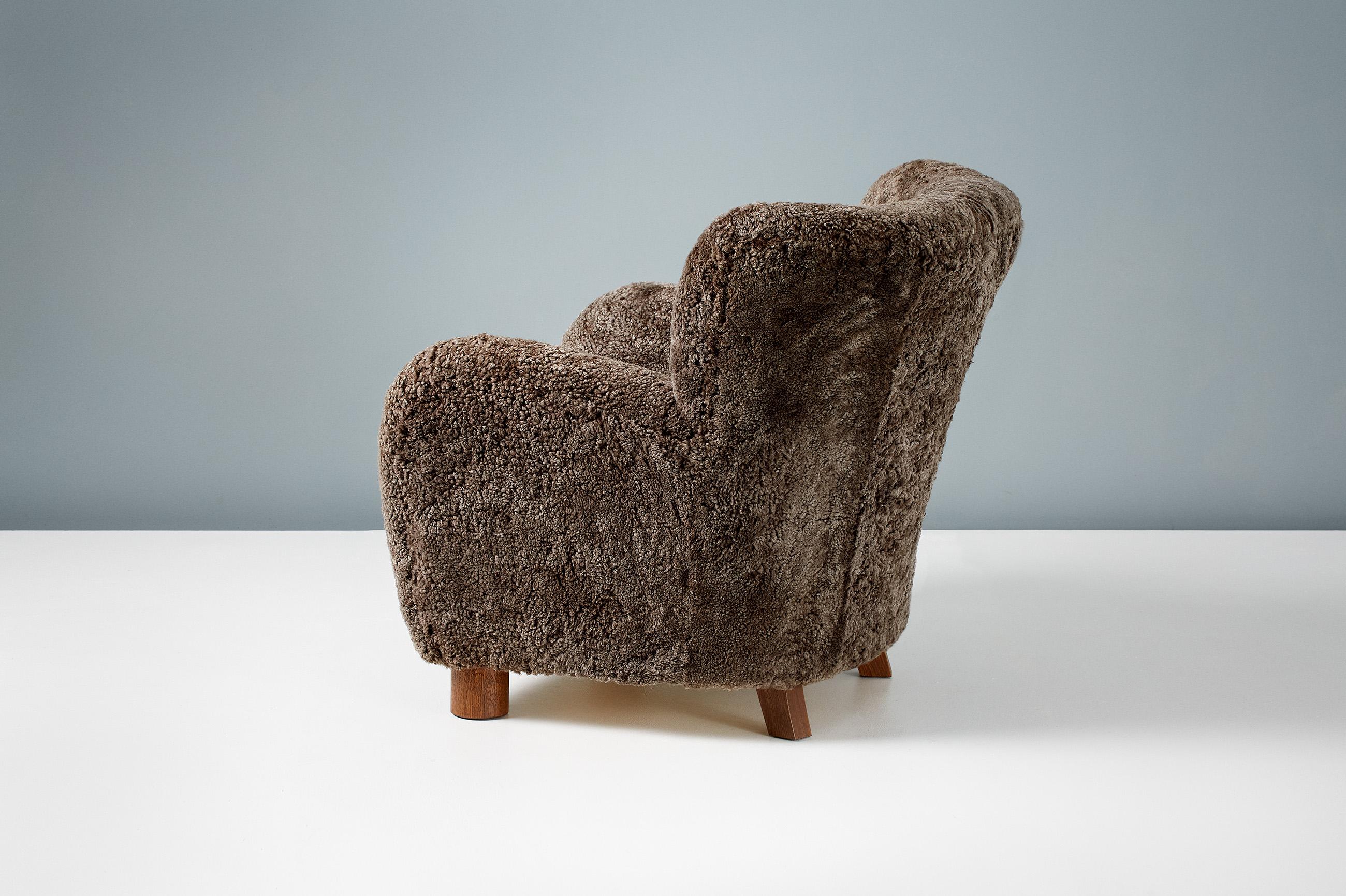A custom-made lounge chair developed & produced at our workshops in London using the highest quality materials. This chair has been upholstered in luxurious brown Australian sheepskin and has fumed oak legs.
