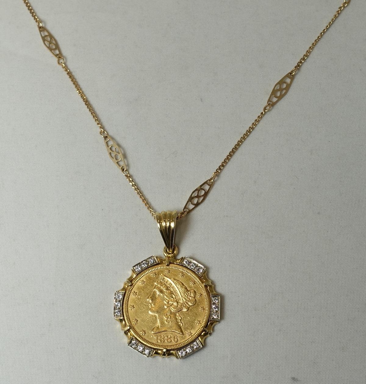 This is a stunning, custom made coin necklace features a 22 karat gold 1886 coin, with 3/4 carats of diamond accents with a 14 karat gold Deco chain necklace with spring clasp.  The 22 karat gold coin measures 1” in diameter/across; the 14 karat