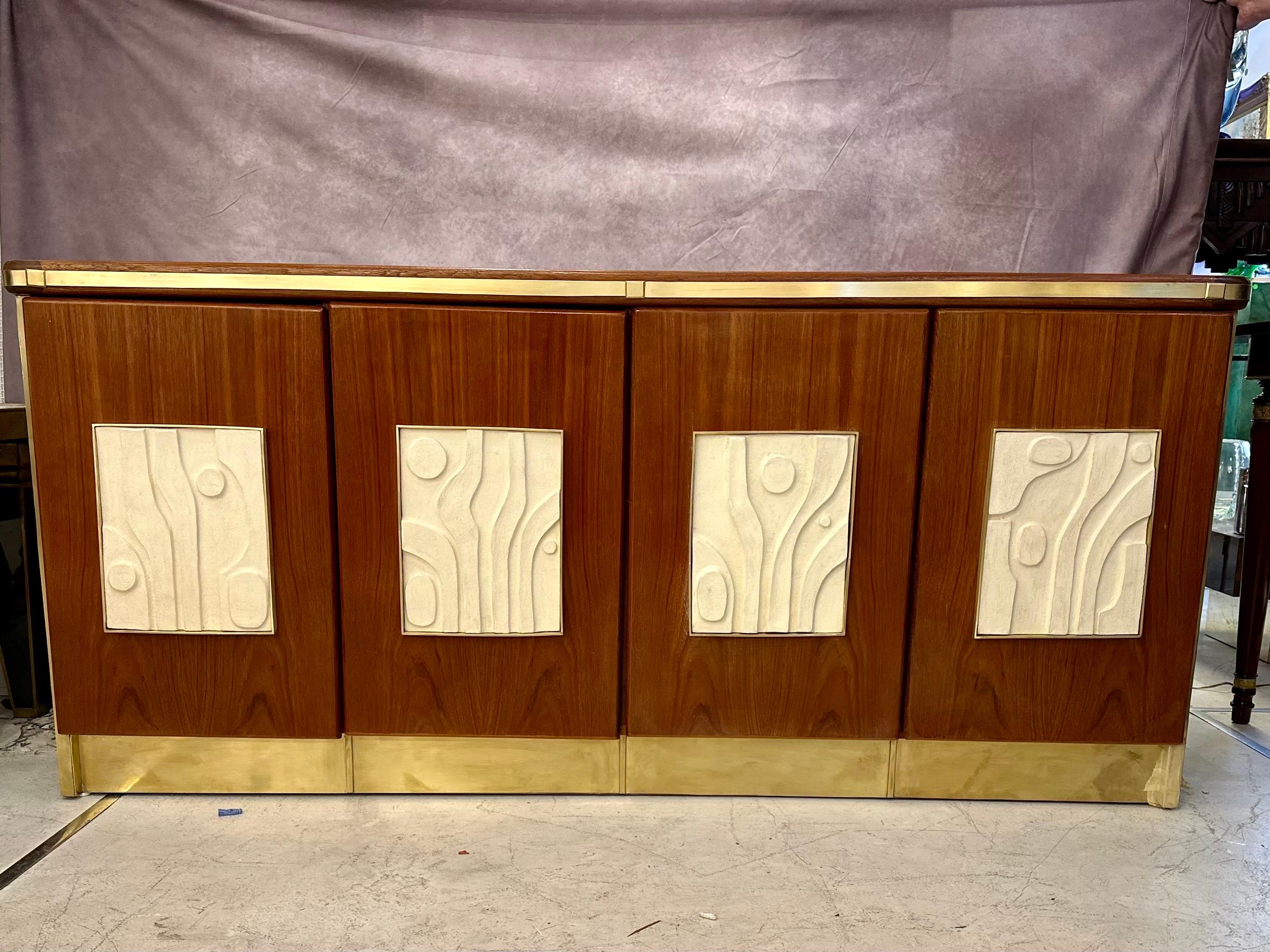 This unique creation is a midcentury and modern mixture. The wood credenza is a midcentury bespoke piece that’s been buffered and polished to redeem its former beauty. The gorgeous handmade ceramic inlays are custom fitted to this piece. The French
