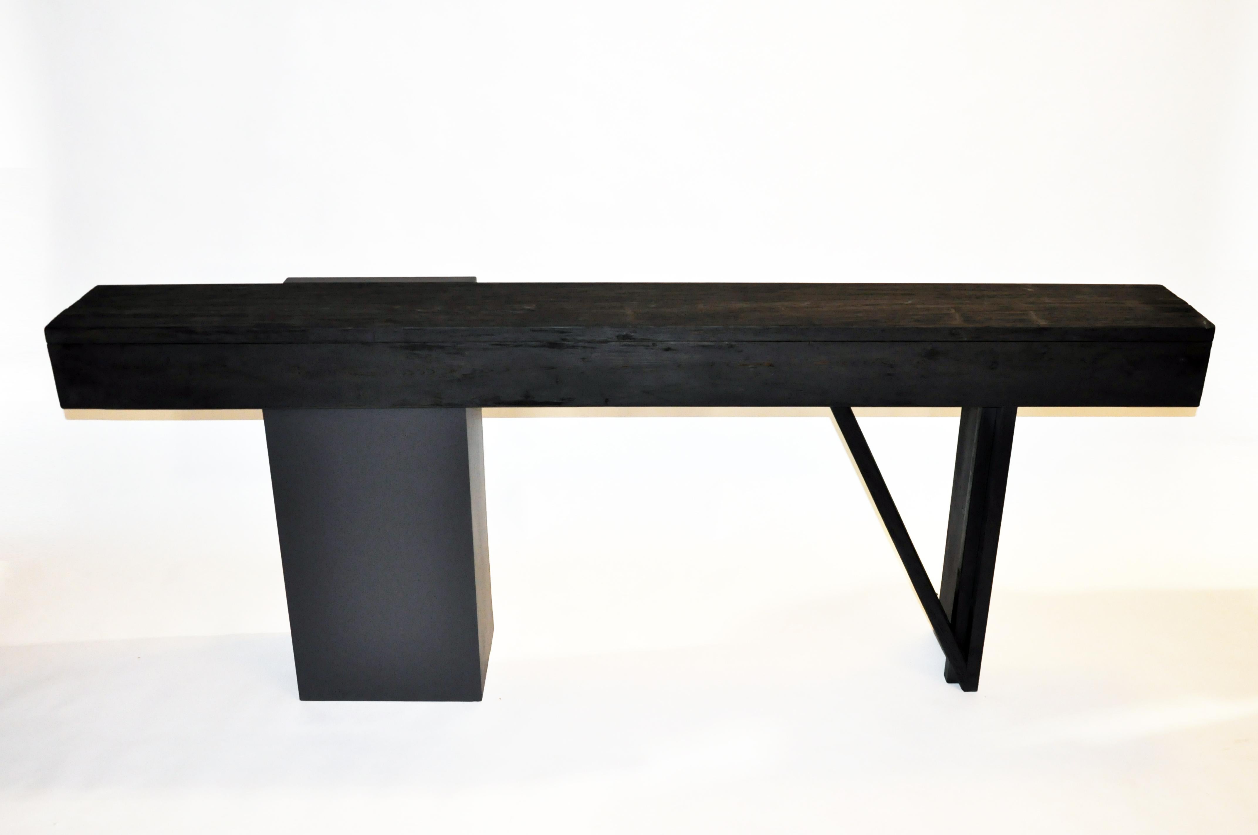 This custom made altar table was made from reclaimed cedar wood, MDF, and black paint circa 2021 in Chicago. The tabletop is cedarwood with parts of the base being MDF. The table has been made black for a clean and modern feel.
 