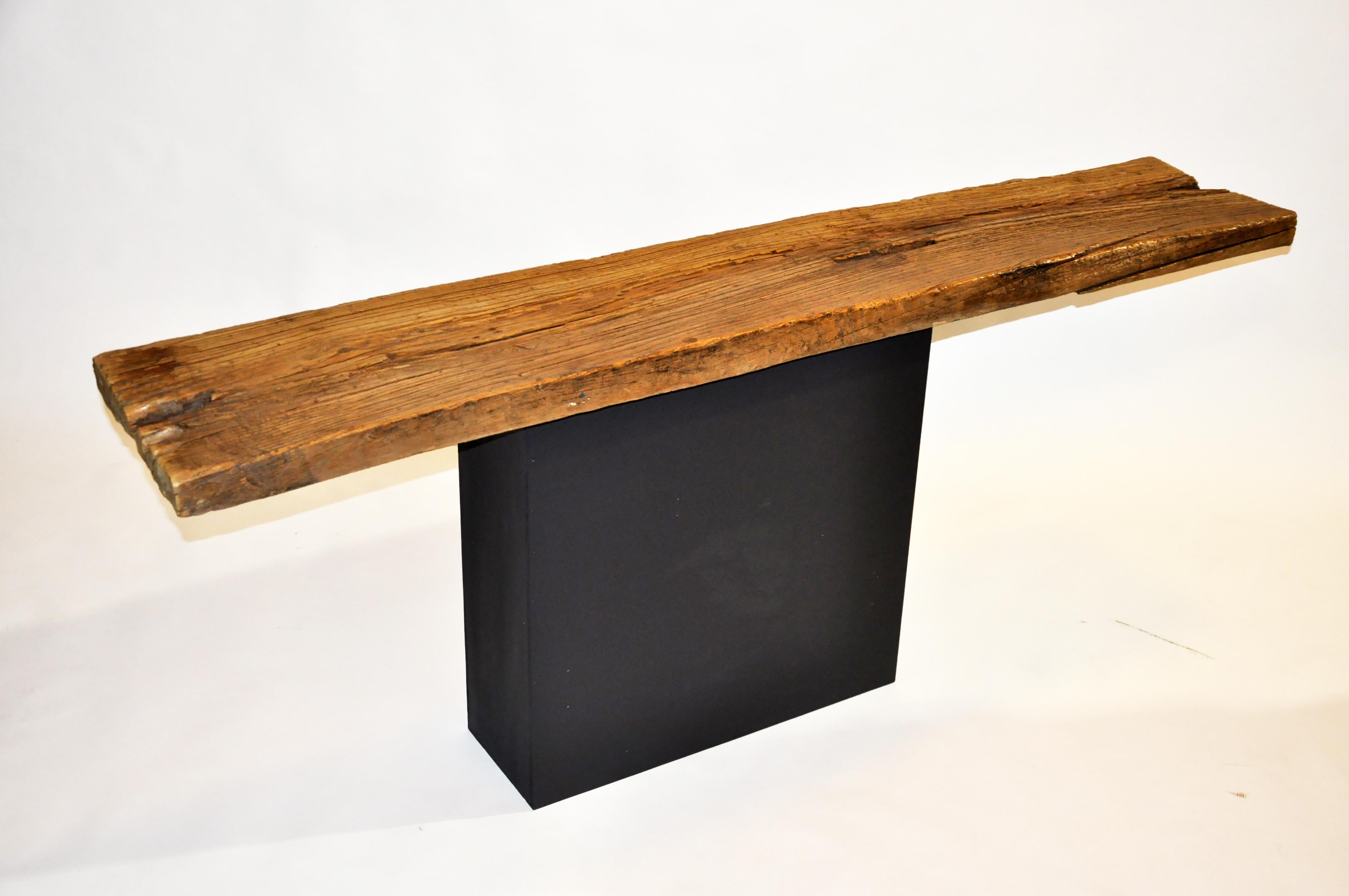 This altar table was made from reclaimed elm wood, MDF, and black paint circa 2021 in Chicago. The tabletop is a reclaimed elmwood piece that has been repurposed as an altar table. Wear is consistent with age and use. The tabletop is from one piece