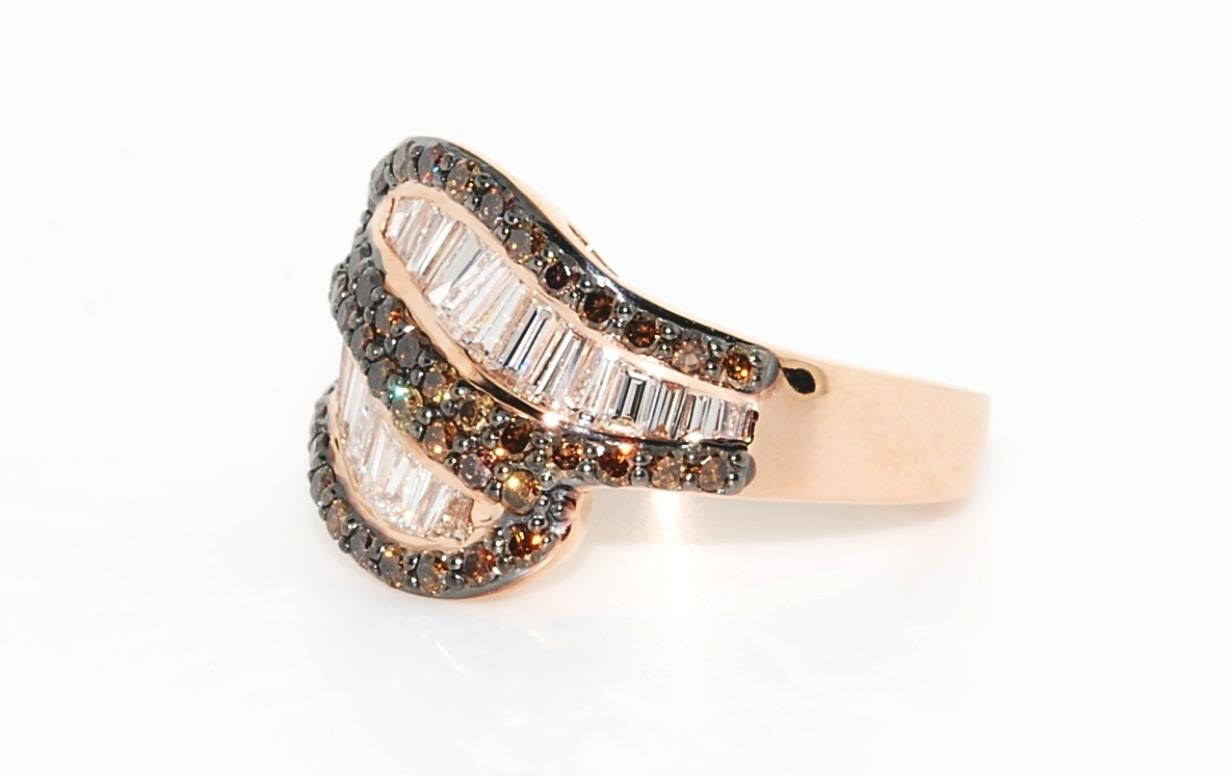 Custom design by Erica Sanchez-Hawkins, with a euro shank design in 8.5 grams of 14 karat rose gold. This ring features selected diamonds...48 round full cut CoCo diamonds VS2 clarity that total .65 carats and 26 baguette diamonds F color and VS