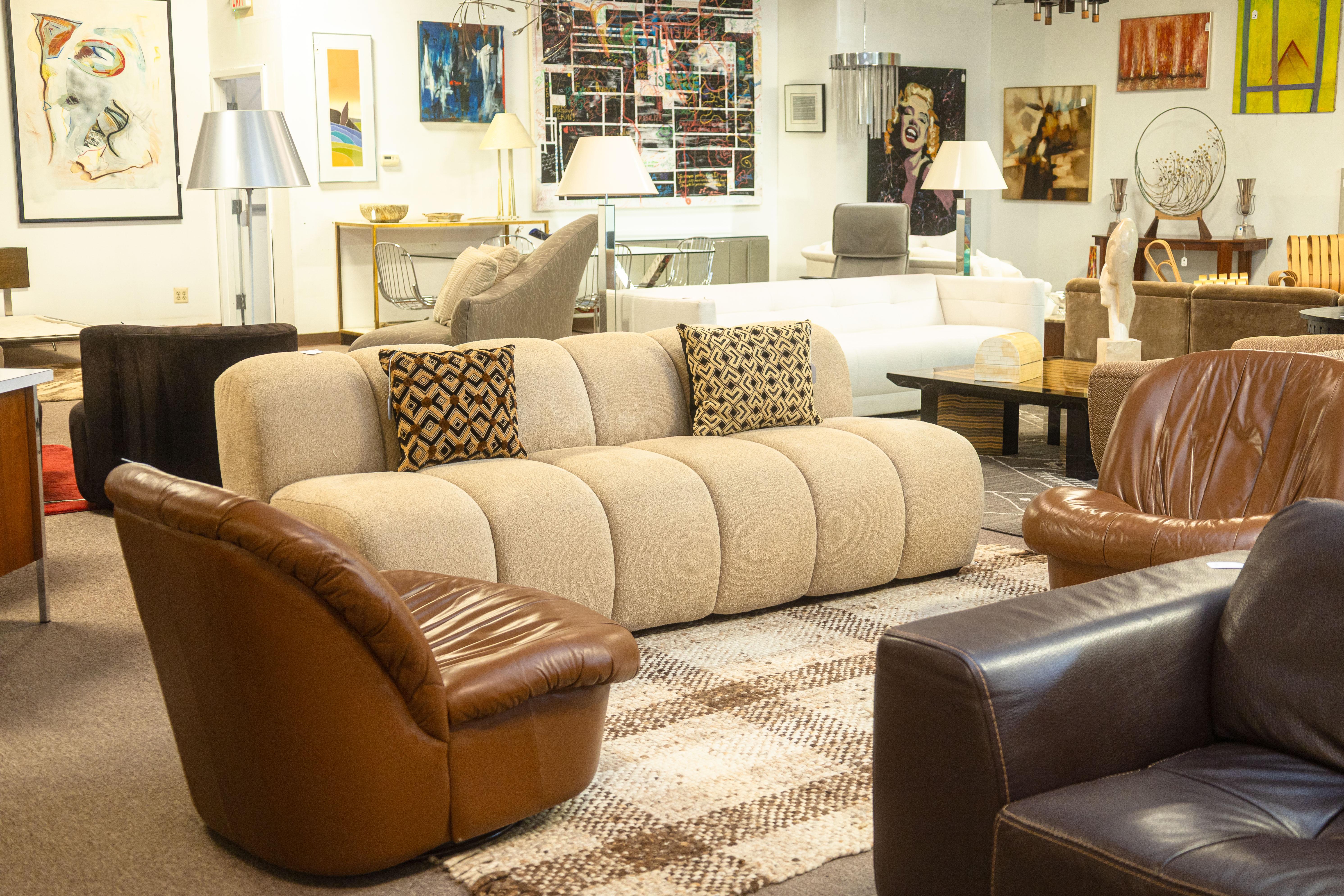 A custom made beige tufted accent sofa. This is a super beautiful contemporary sofa, custom made with extremely high quality materials. This sofa features a beige boucle fabric, with large tufted grooves going up and down the whole front side of the