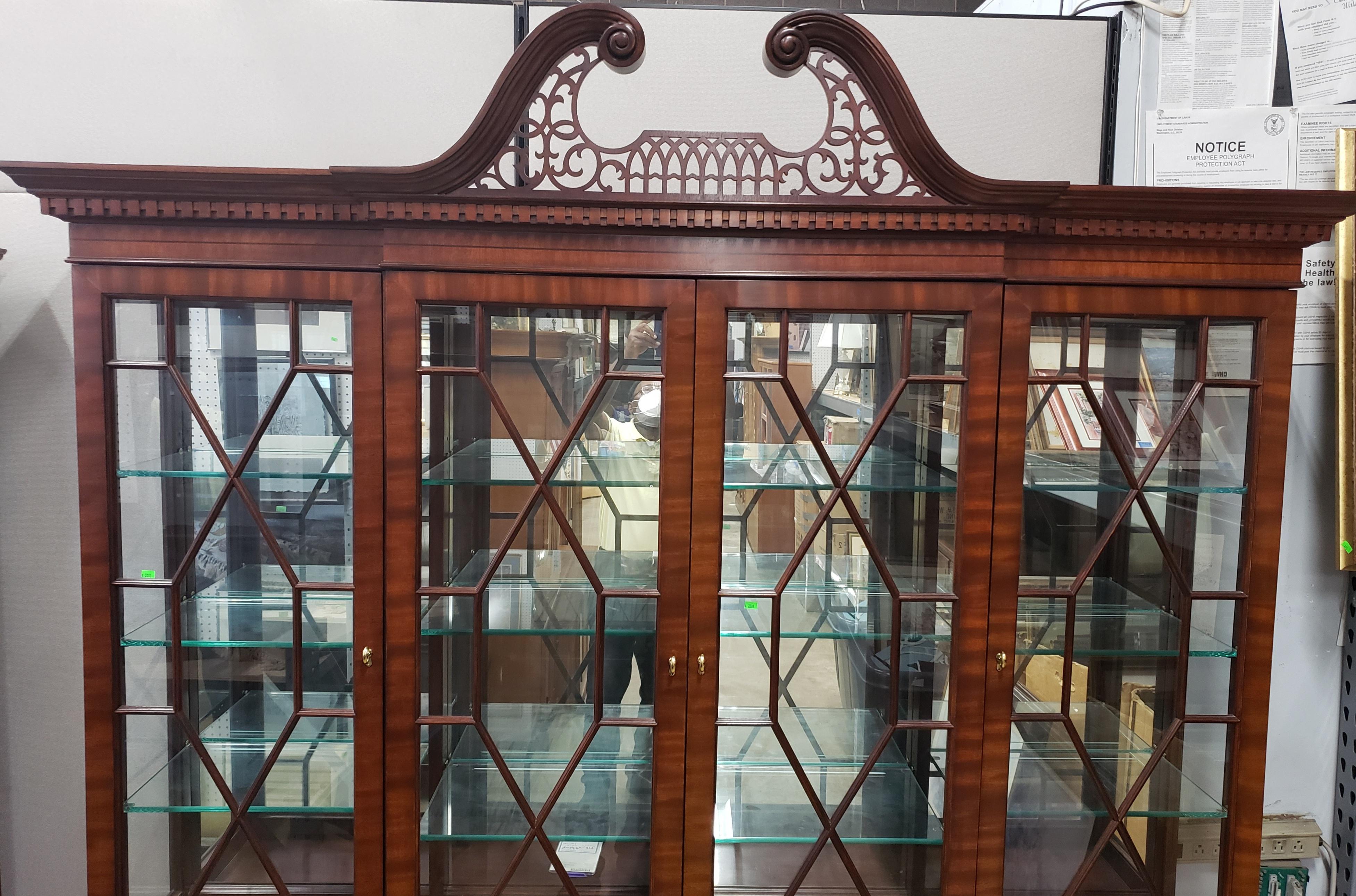 Custom made breakfront by Councill Furniture. This flame mahogany breakfront china cabinet or bookcase. There is four drawers behind doors of lower center section, too drawer lined and partitioned for silverware. end sections of base have adjustable