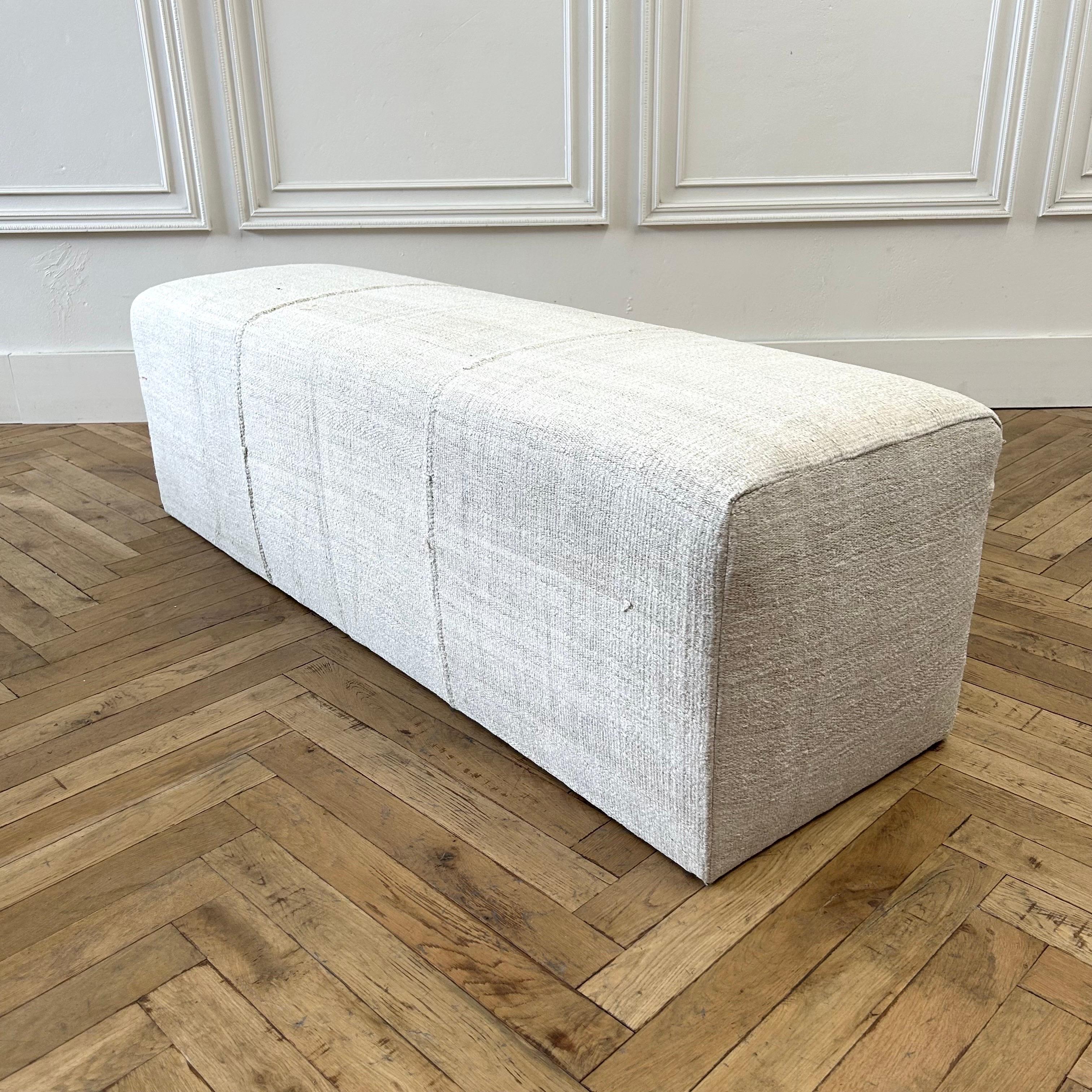 Cube ottoman 60”w x 18”d x 18”h
Beautiful Custom Made cube ottoman 
Made from a vintage turkish hemp and wool rug, in an off white, with original beautiful hand tied stitched center seam. Original seams, sewn with an overlock under to prevent any