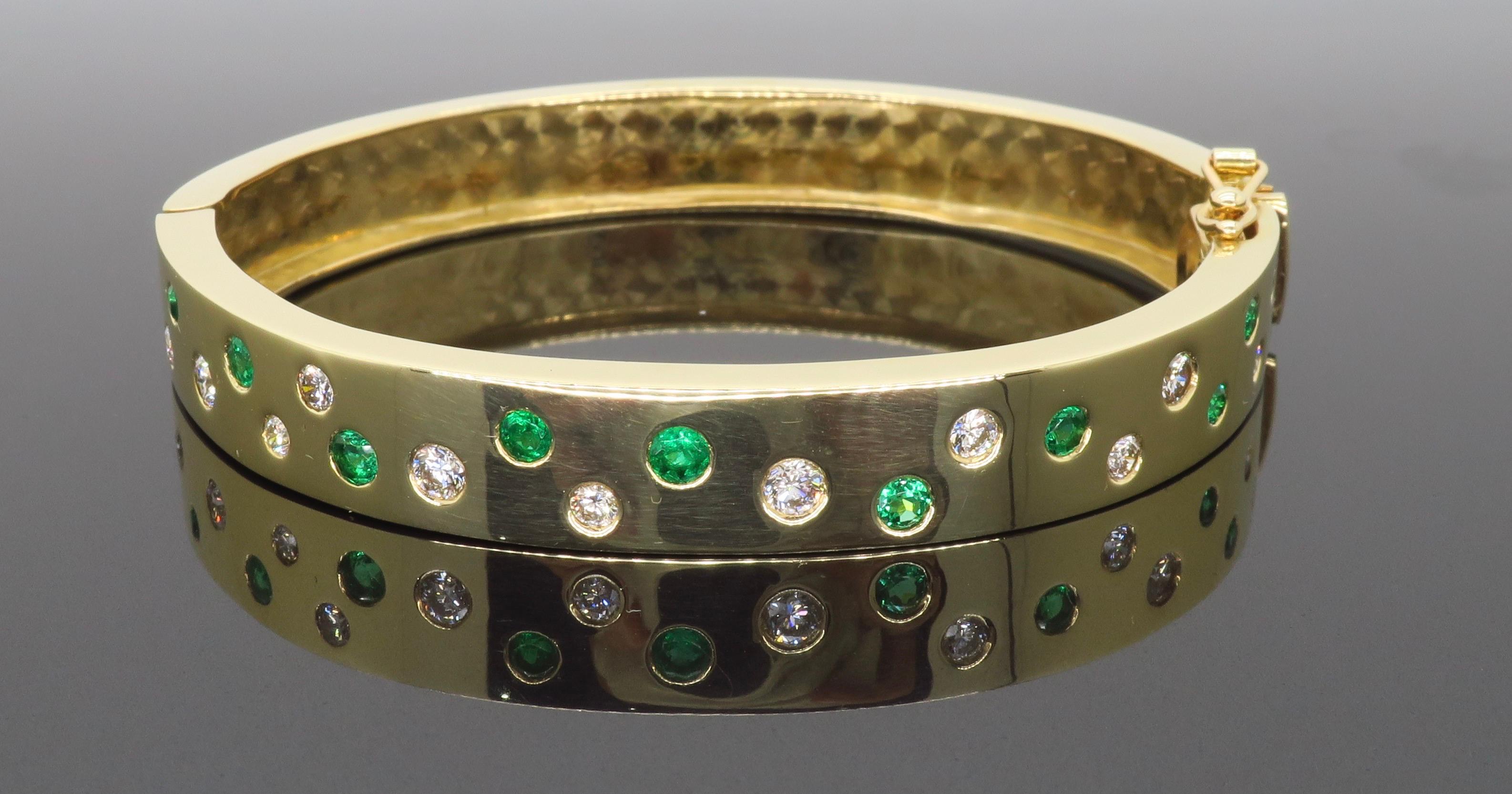 Custom made “bubble” style diamond & emerald bangle bracelet made in 14k yellow gold. 

Diamond Carat Weight: Approximately 1.00CTW
Diamond Cut: Round Brilliant Cut Diamonds
Color: Average G-H
Clarity: Average VS
Metal: 14k yellow