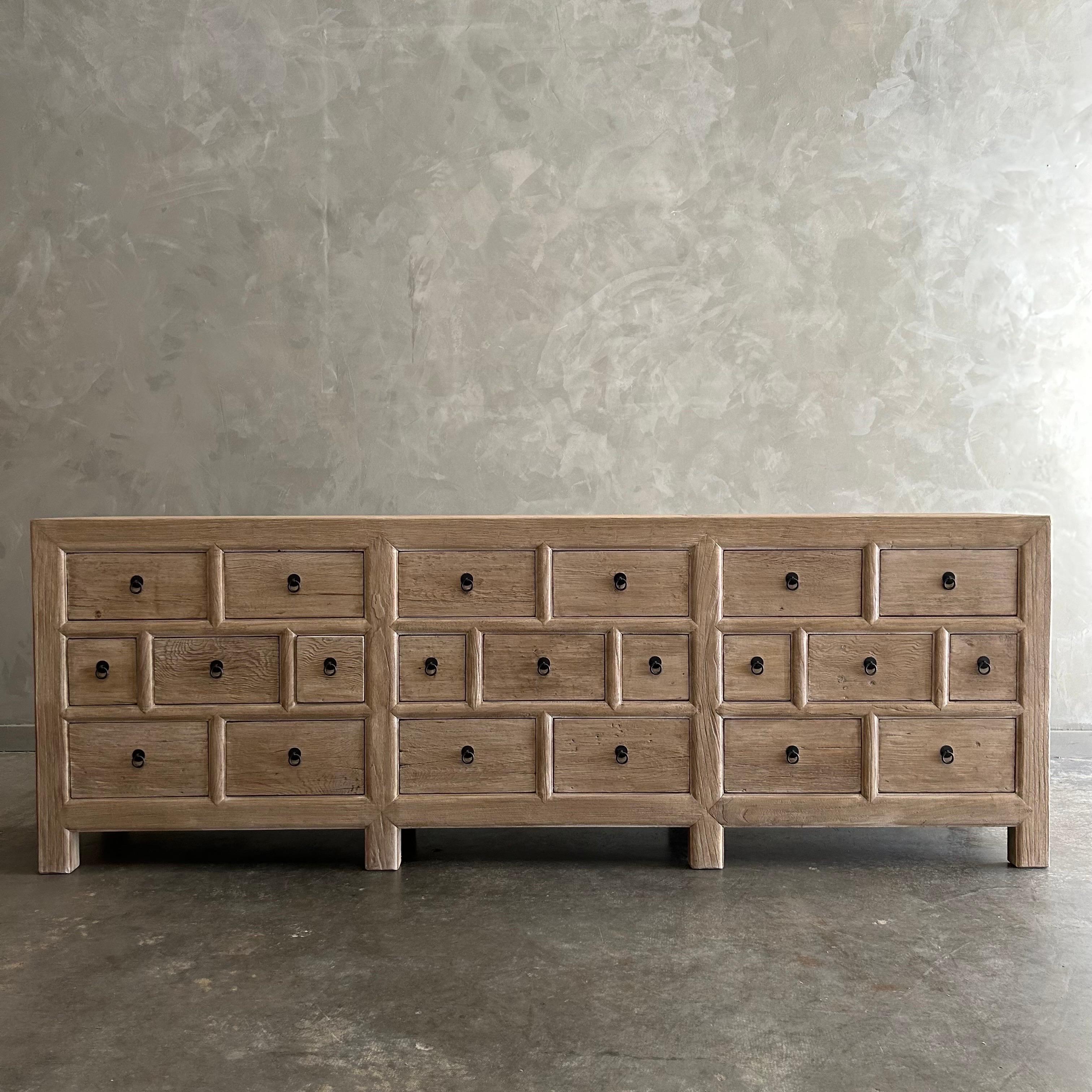 CARY SIDEBOARD IN NATURAL FINISH
Made from salvaged reclaimed timbers, this console is reminiscent of antique apothecary cabinets. Featuring 21 drawers for ample storage and a distinctive weathered finish, this rustic sideboard adds a unique touch