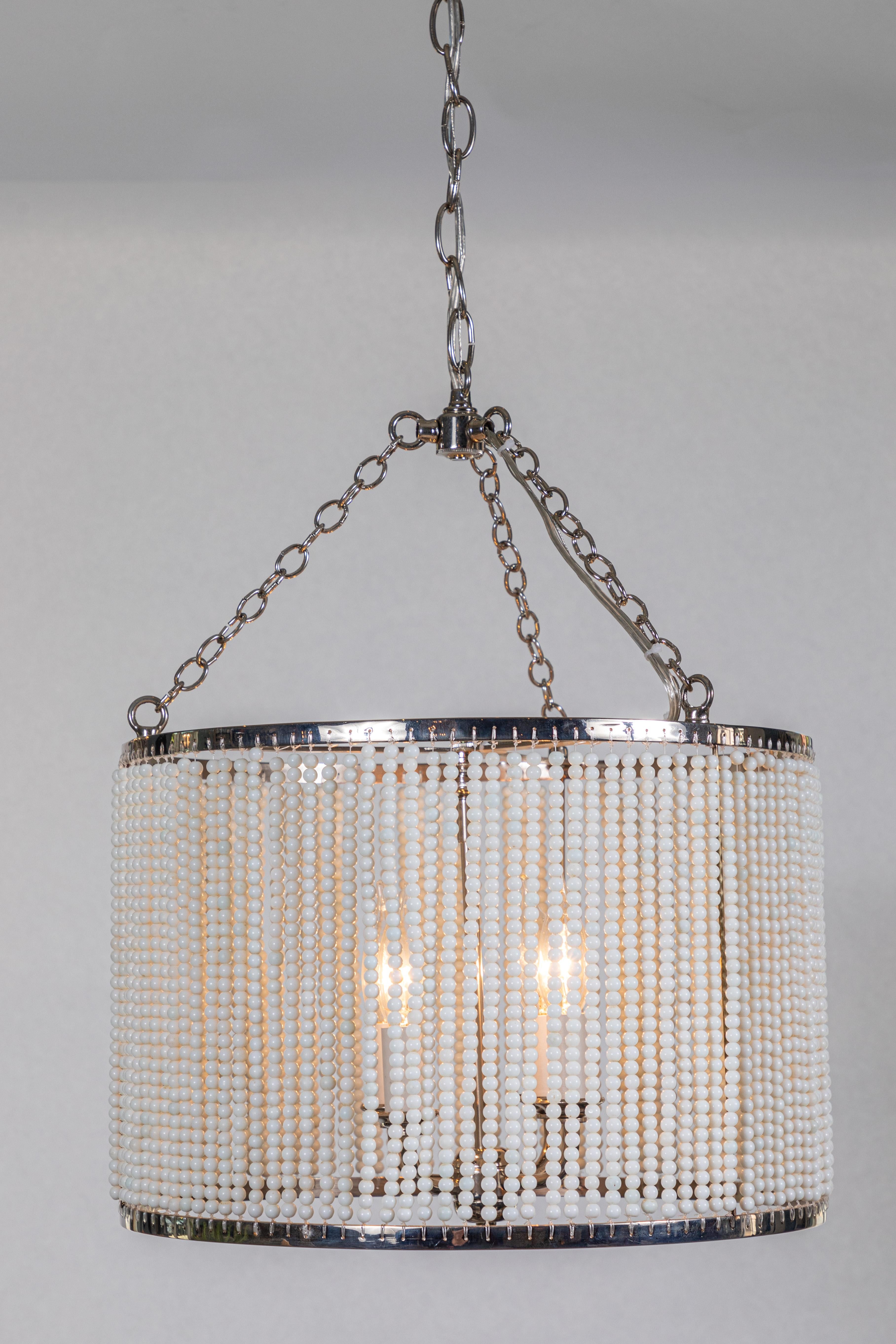 Custom made hanging polished nickel drum pendant light with strung white glass bead detailing.