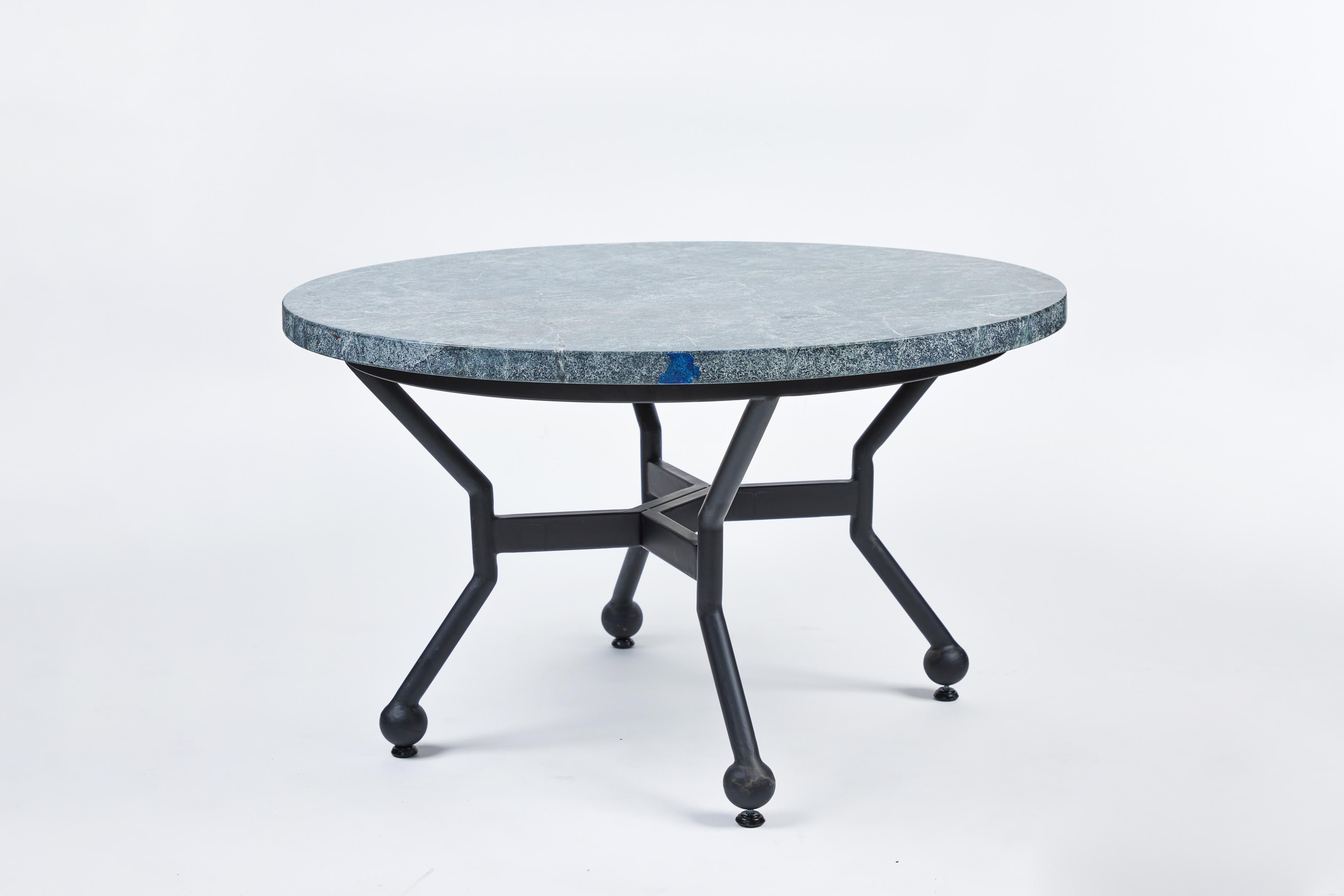 This striking custom round two-piece iron coffee table has an attractive new soapstone top with beautiful rounded edges and rich natural markings. It has been powder coated in a rich black finish to complement the deep green tones of the natural