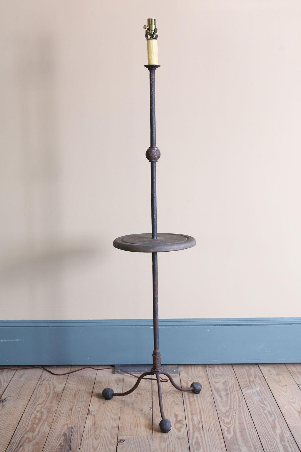 We make this lamp for our shop. It is nice for spaces where there is not room for a table and a light is needed.
It is forged iron and carved wood and hand-fished and wired here in Houston. The height measurement is to the top of the socket. A