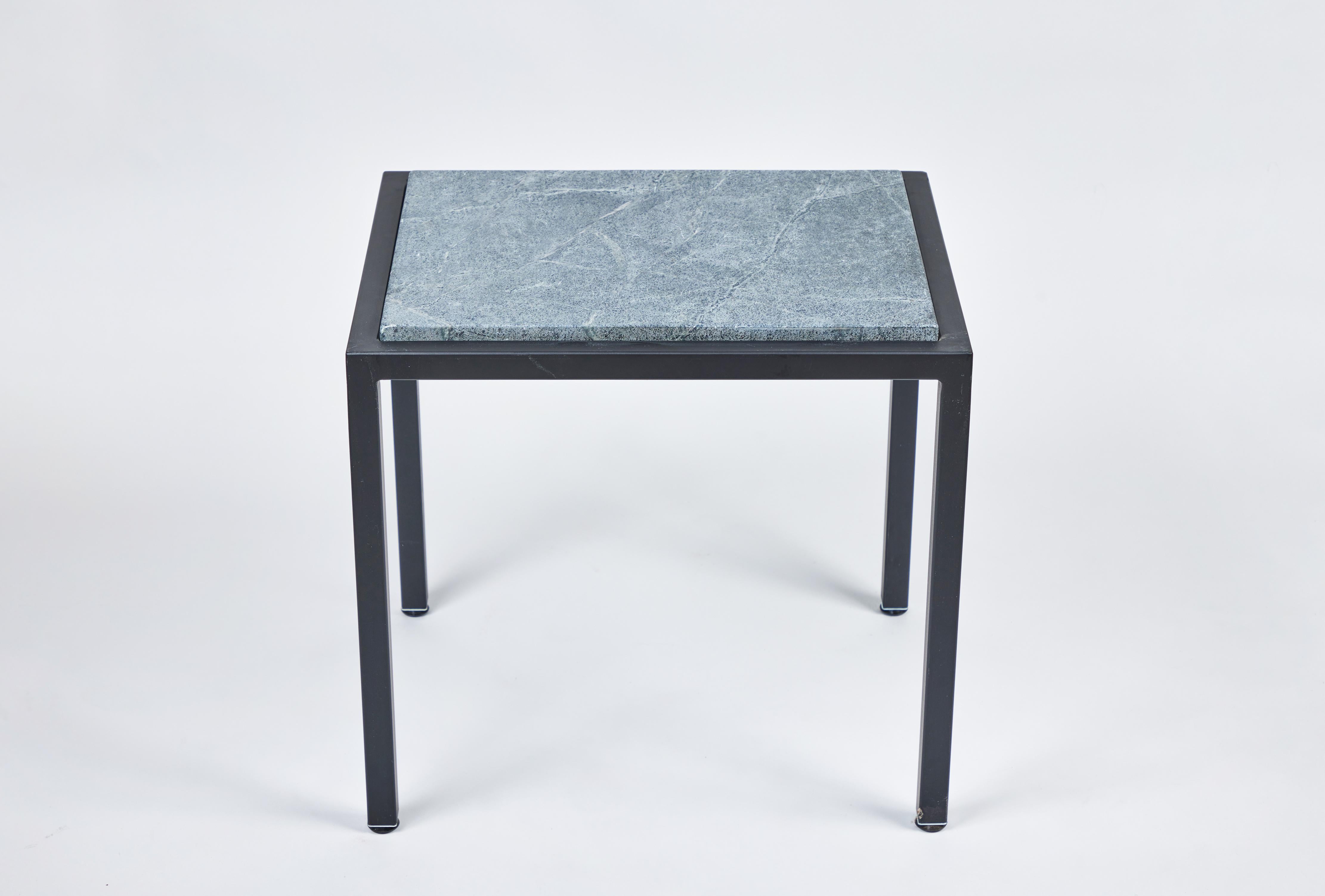 This fantastic custom compact rectangular two-piece iron side table has an attractive new soapstone top with beautiful rounded edges. It has been powder coated in a rich black finish to complement the deep green tones of the natural stone. It is the