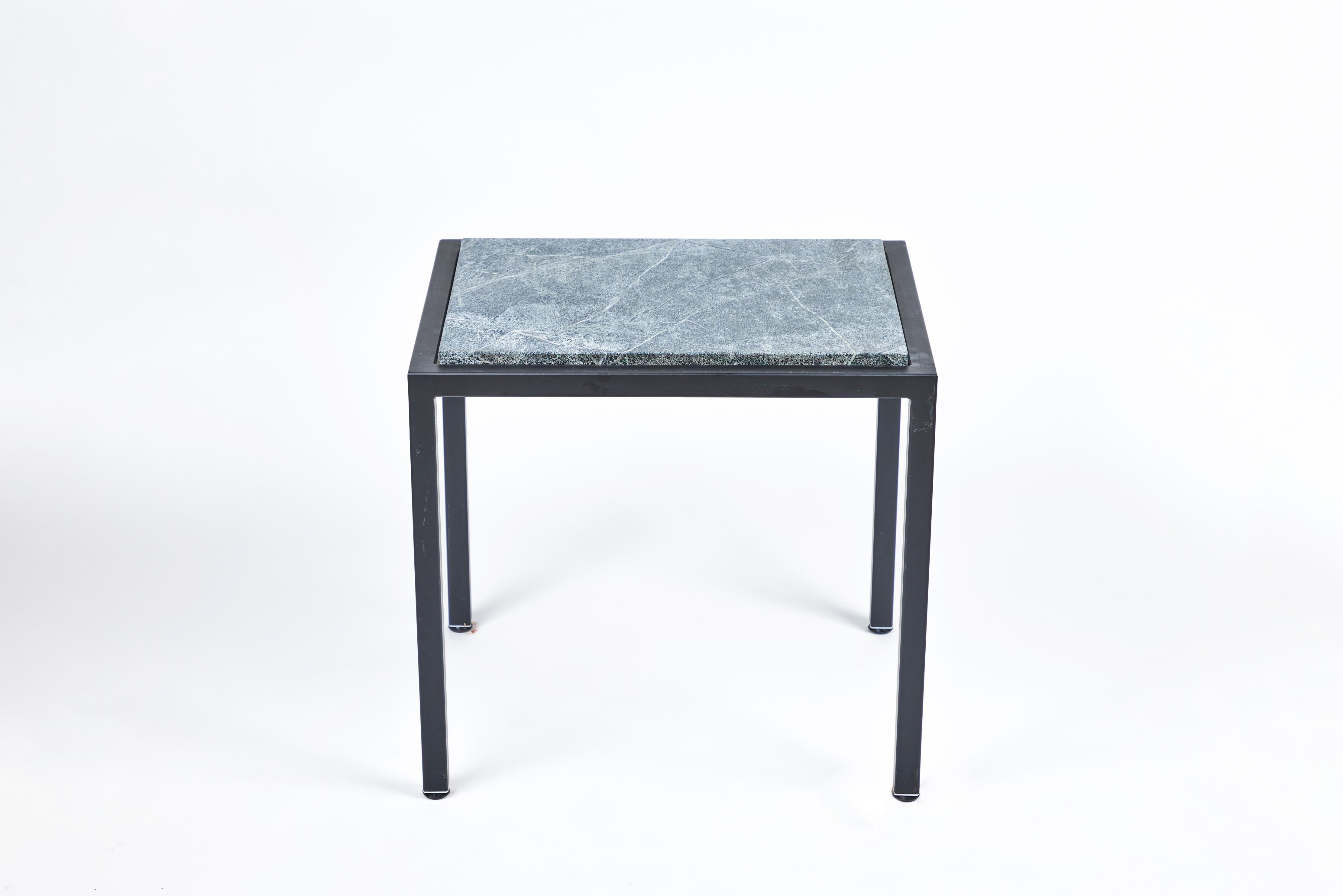 This fantastic custom compact rectangular two-piece iron side table has an attractive new soapstone top with beautiful rounded edges. It has been powder coated in a rich black finish to complement the deep green tones of the natural stone. It is the