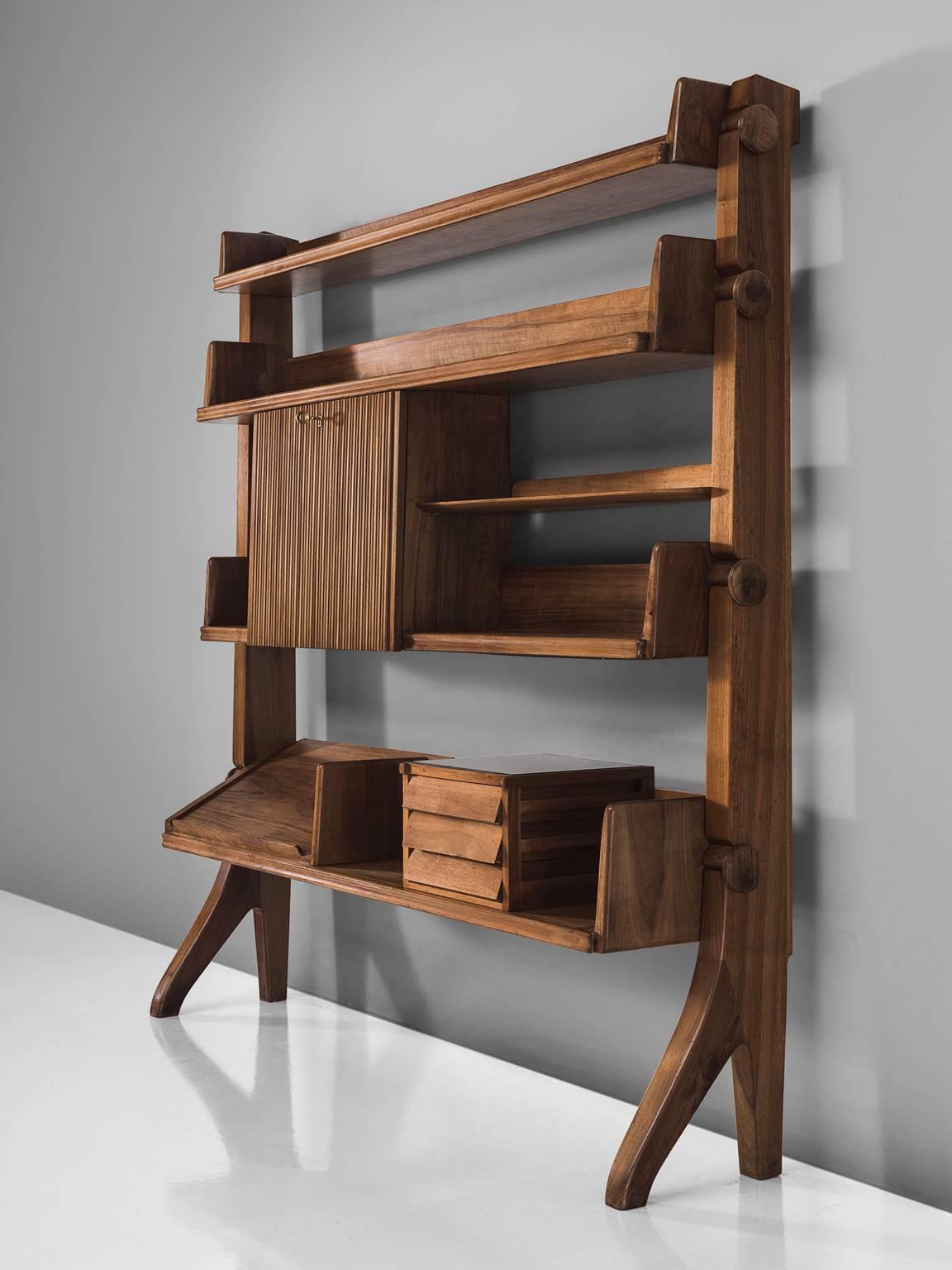 Bookcase, walnut, Italy, 1940s. 

This exclusive walnut library is made out of walnut and holds fixed cabinets. It is made with the utmost precision and finish. This library has a strong, refined aesthetic and features different compartments. The