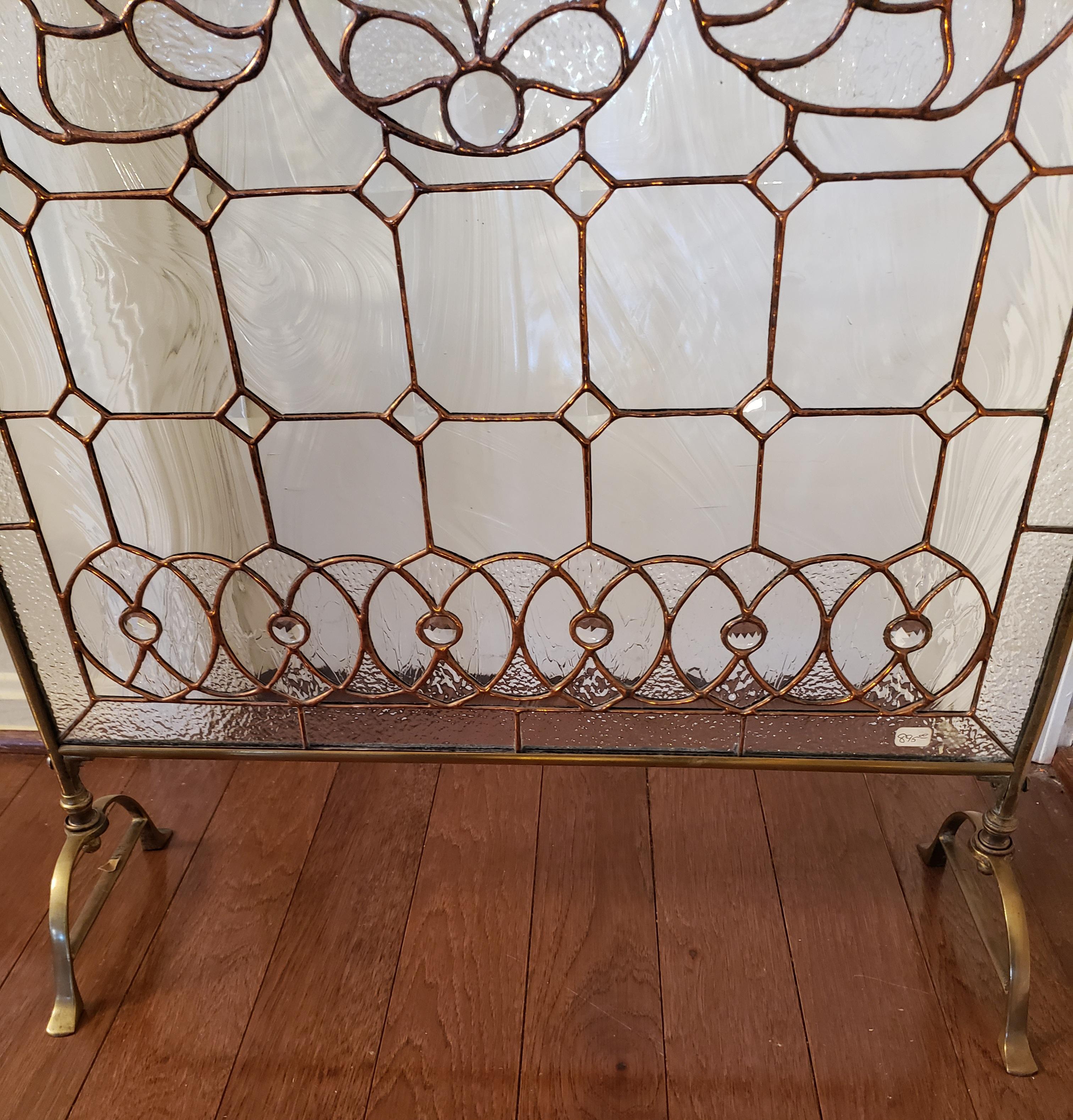 Lovely Victorian period custom made leaded stained glass fire place screen with brass frame. Various textured with clear glass.
Very good antique condition.
Measures approximately 23