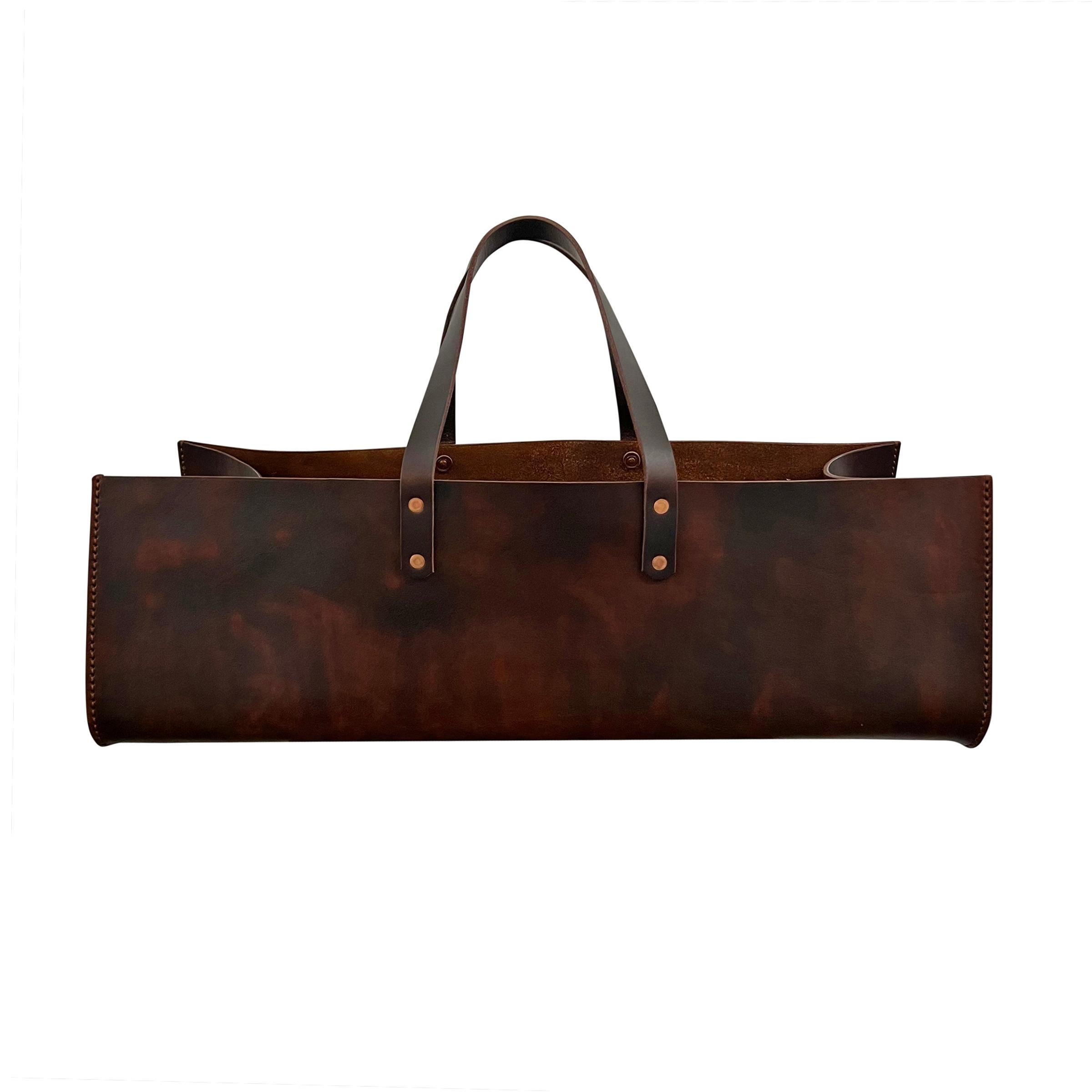 Elevate your gardening experience with this exquisite custom leather garden trug, designed by RIGHT PROPER, and meticulously crafted by a skilled artisan in England. Crafted from hand-dyed belting leather and secured with hand-hammered copper