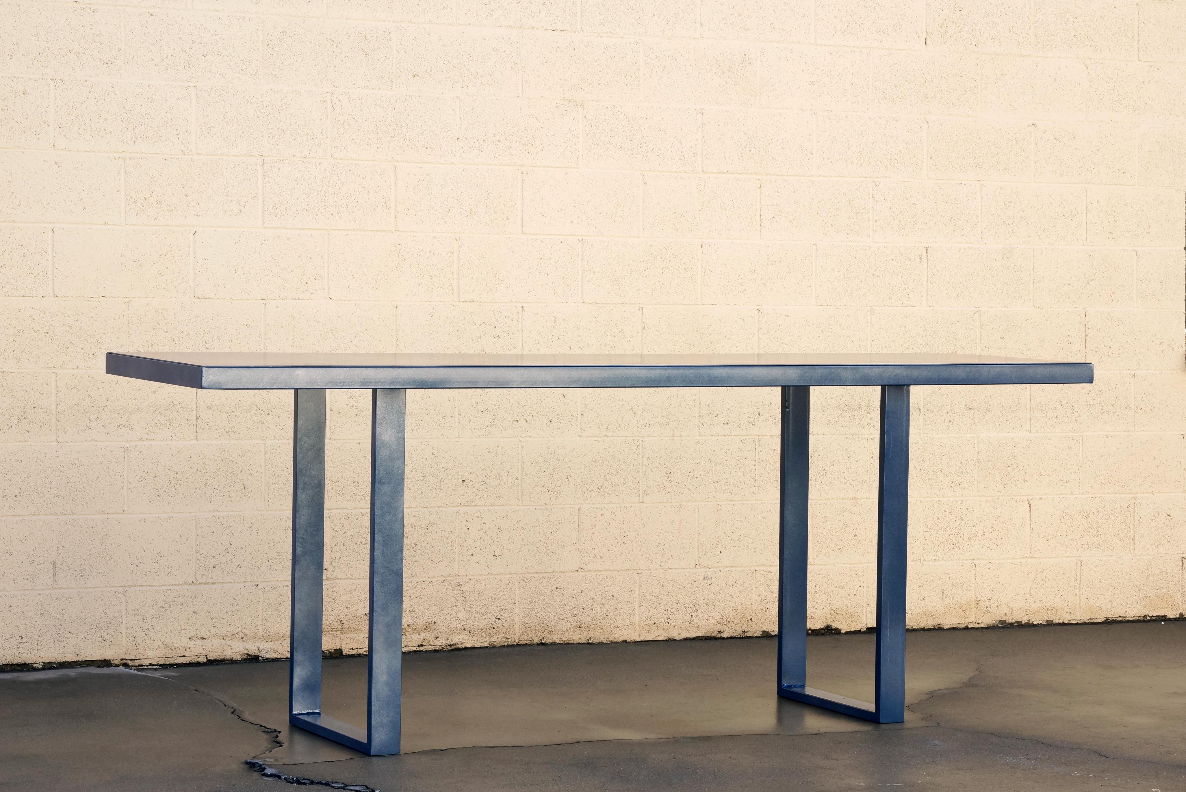 Our custom made Minimalist console/ display table is composed of a rectangular tubing frame with a sheet metal top and powder coated in Metallic Midnight Blue. With it's sleek lines and geometric aesthetic, it's as good looking as it is functional.