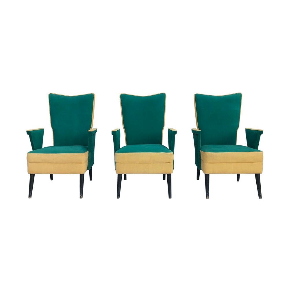 Three Italian 1950s armchairs in their original green and cream/yellow upholstery. The frames have a unique geometric bow design on the arms, and the tall backrests are reminiscent of a throne. The armchairs are a good size, and very