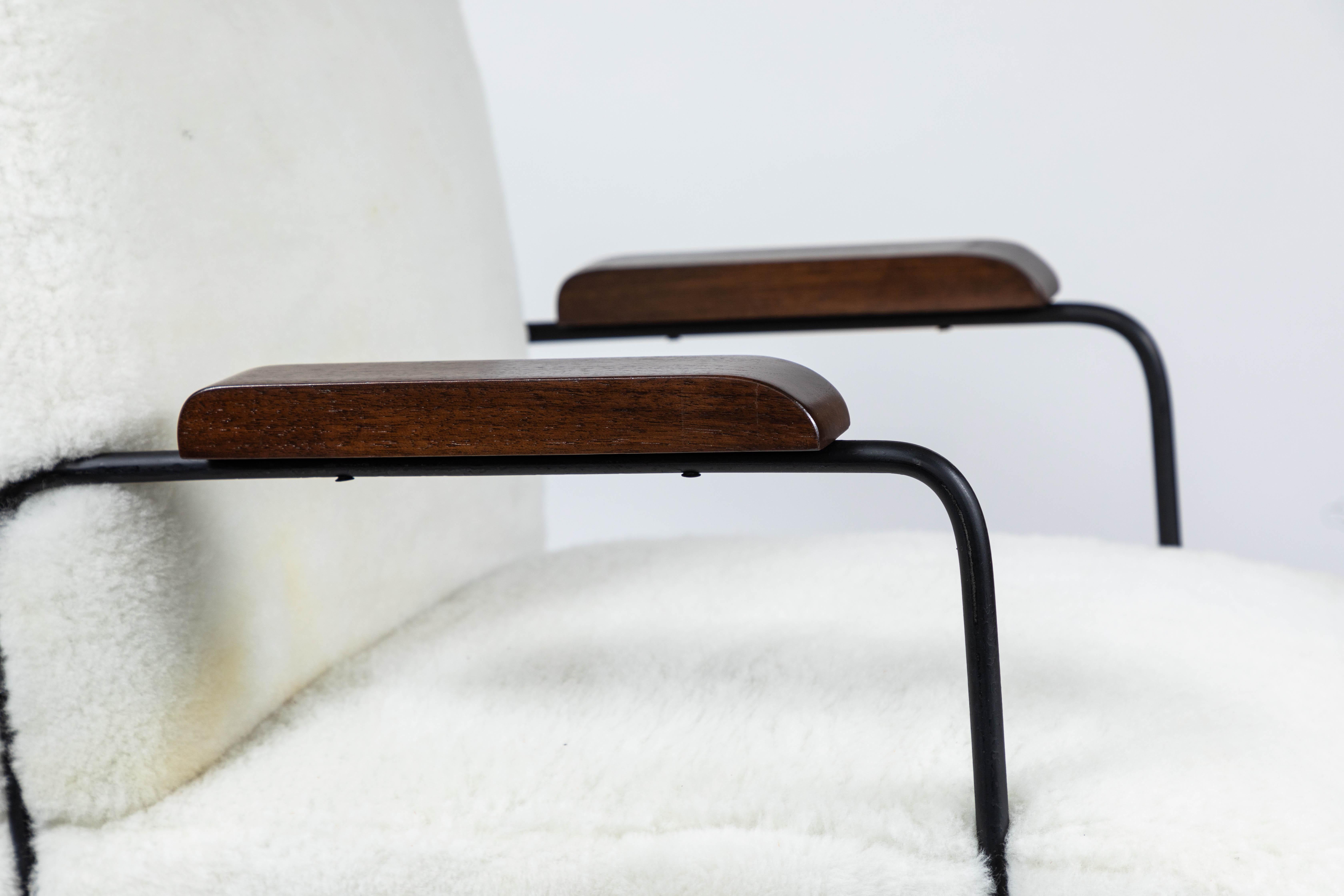 Custom made midcentury style hairpin chair with black iron frame, walnut armrests and upholstery in white shearling.

 