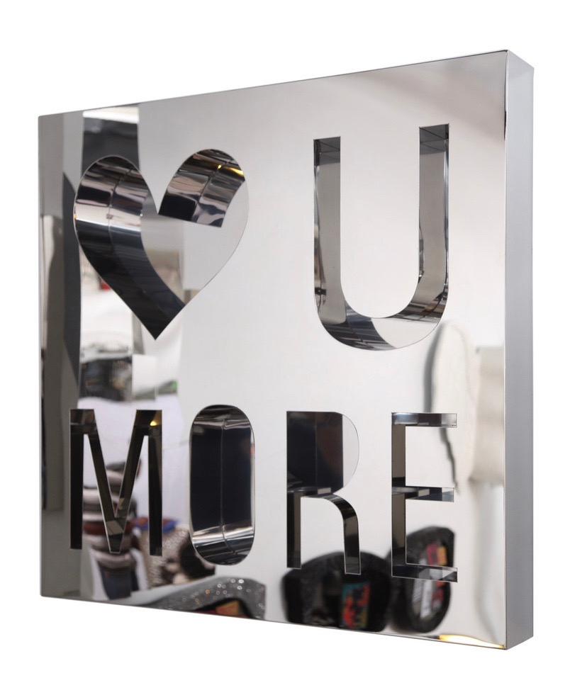 A  LOVE U MORE custom made piece in mirror polished stainless steel conveying a timeless message in a timeless material, steel. A sleek wall art piece made with high quality materials and love..