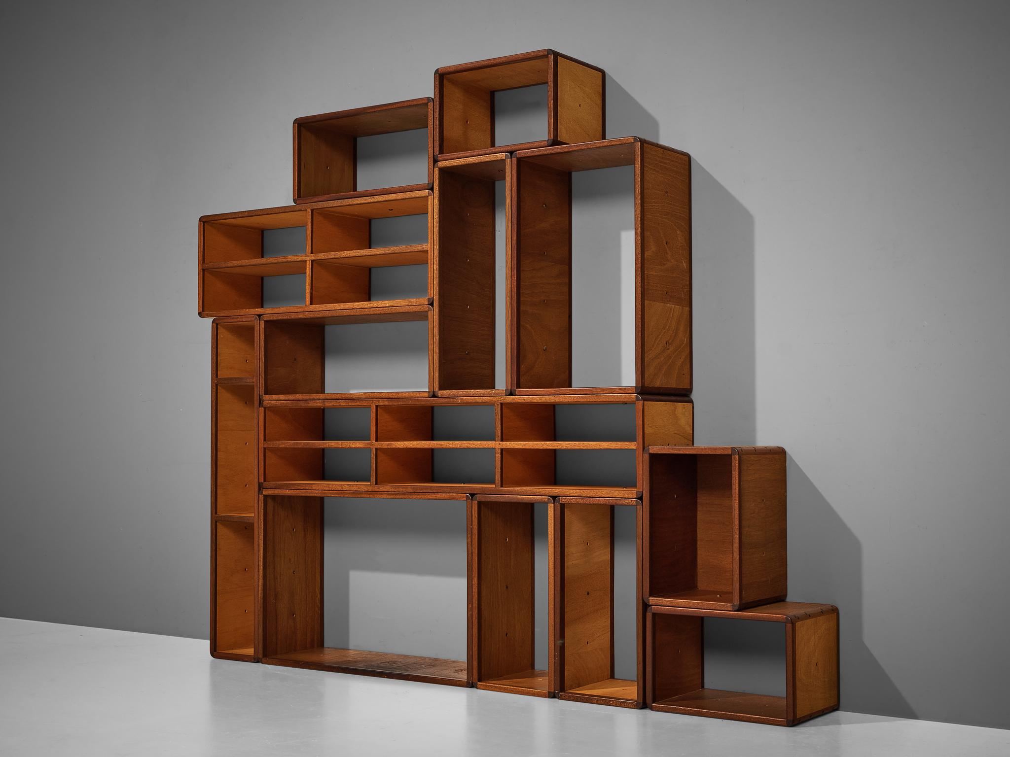 Modular wall unit, teak, mahogany, brass, Germany, 1970s

Adjustable, open wall unit in teak and mahogany. Due to the number of elements, this piece has endless possibilities to arrange them. The cubic components can be used as one large showcase