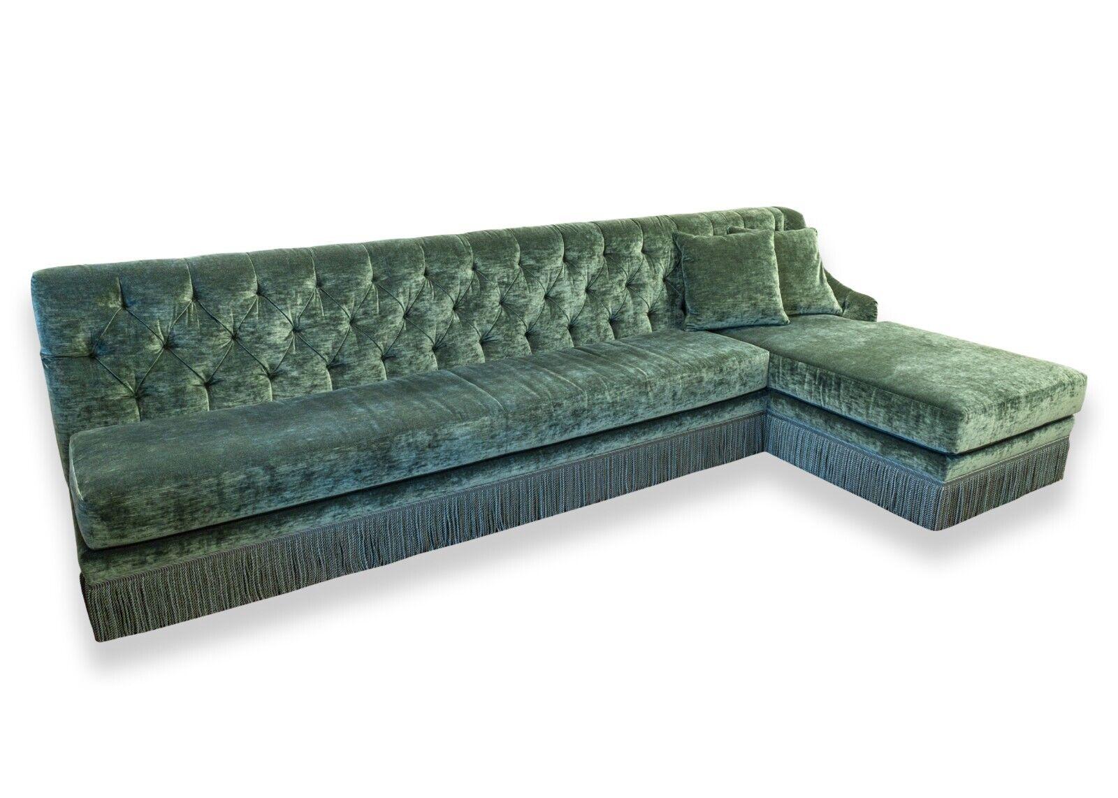 A custom made monumental tufted green velvet Hollywood regency style sectional sofa. Custom made by Keva. This absolutely incredible custom made sofa demands a lot of attention for its elegant design, massive size, and its gorgeous green velvet.