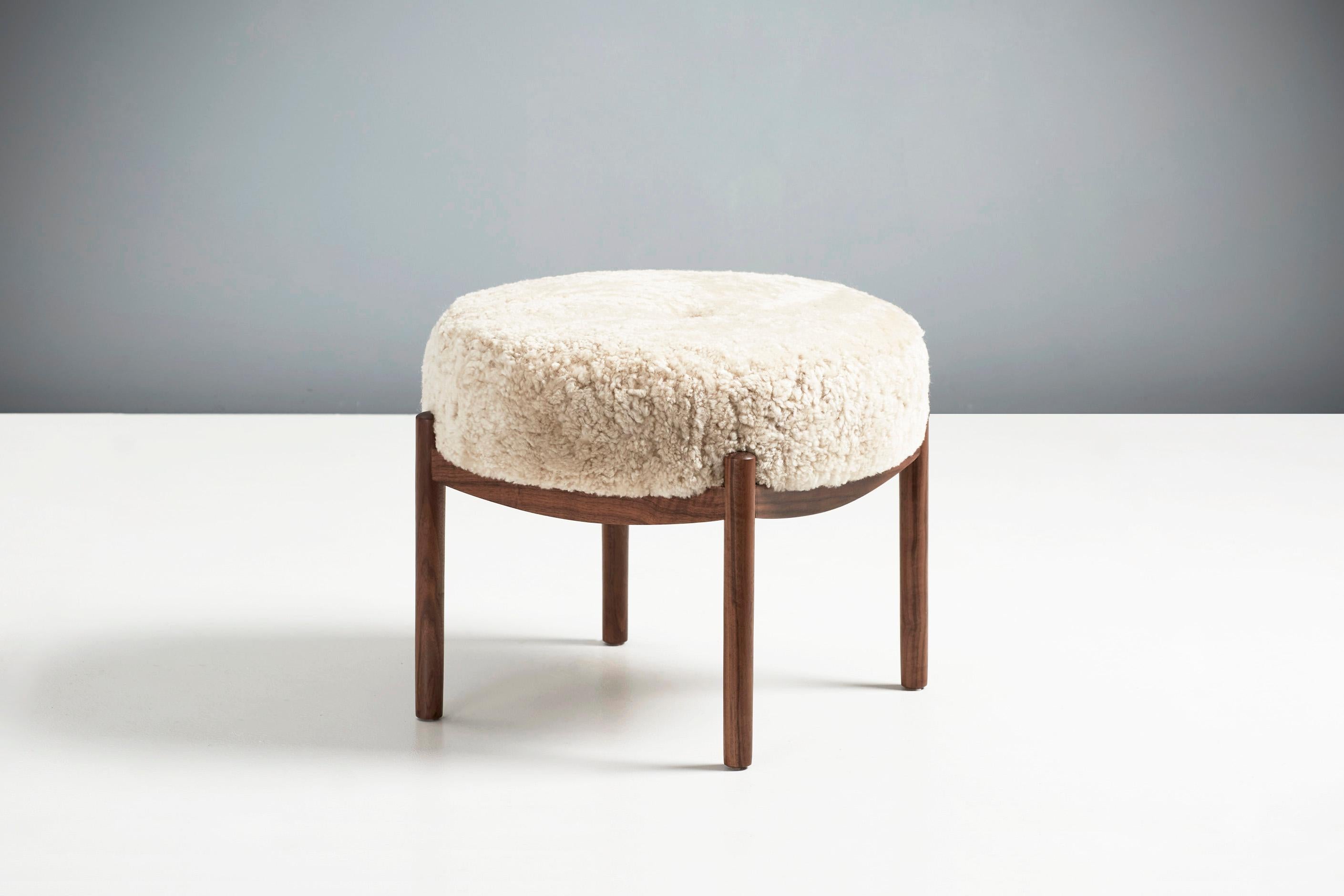 Dagmar Design

Esko Ottoman

A custom-made round ottoman with solid wood frame developed & produced at our workshops in London. This example has an oiled walnut frame with seat upholstered in Moonlight colour sheepskin. The Esko stool is available