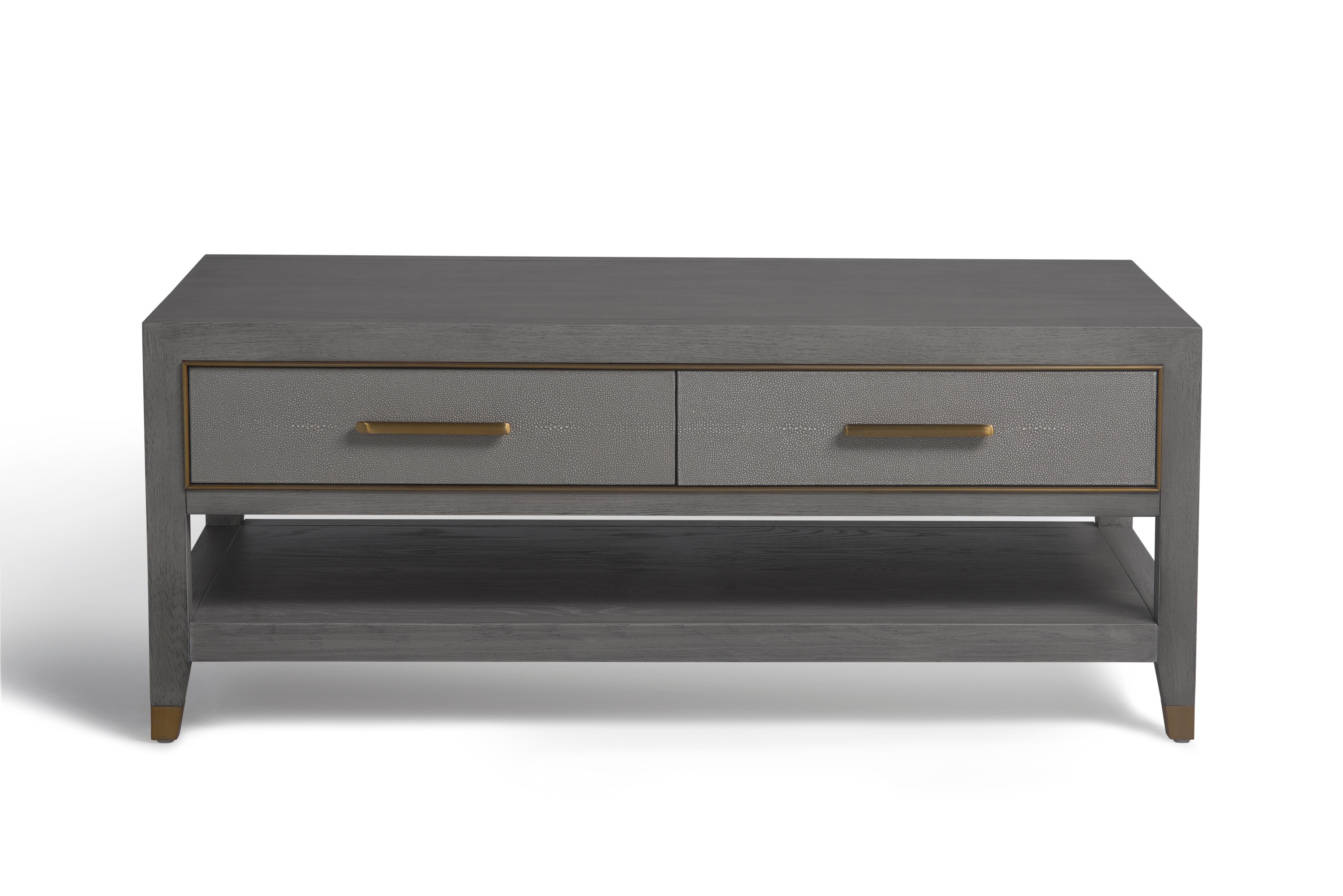 The custom coffee table was requested from the client drawings which also included custom made brass hardware.

Construction of the coffee table is a solid American oak frame with crown random veneer top and shelf. The drawer fronts are shagreen