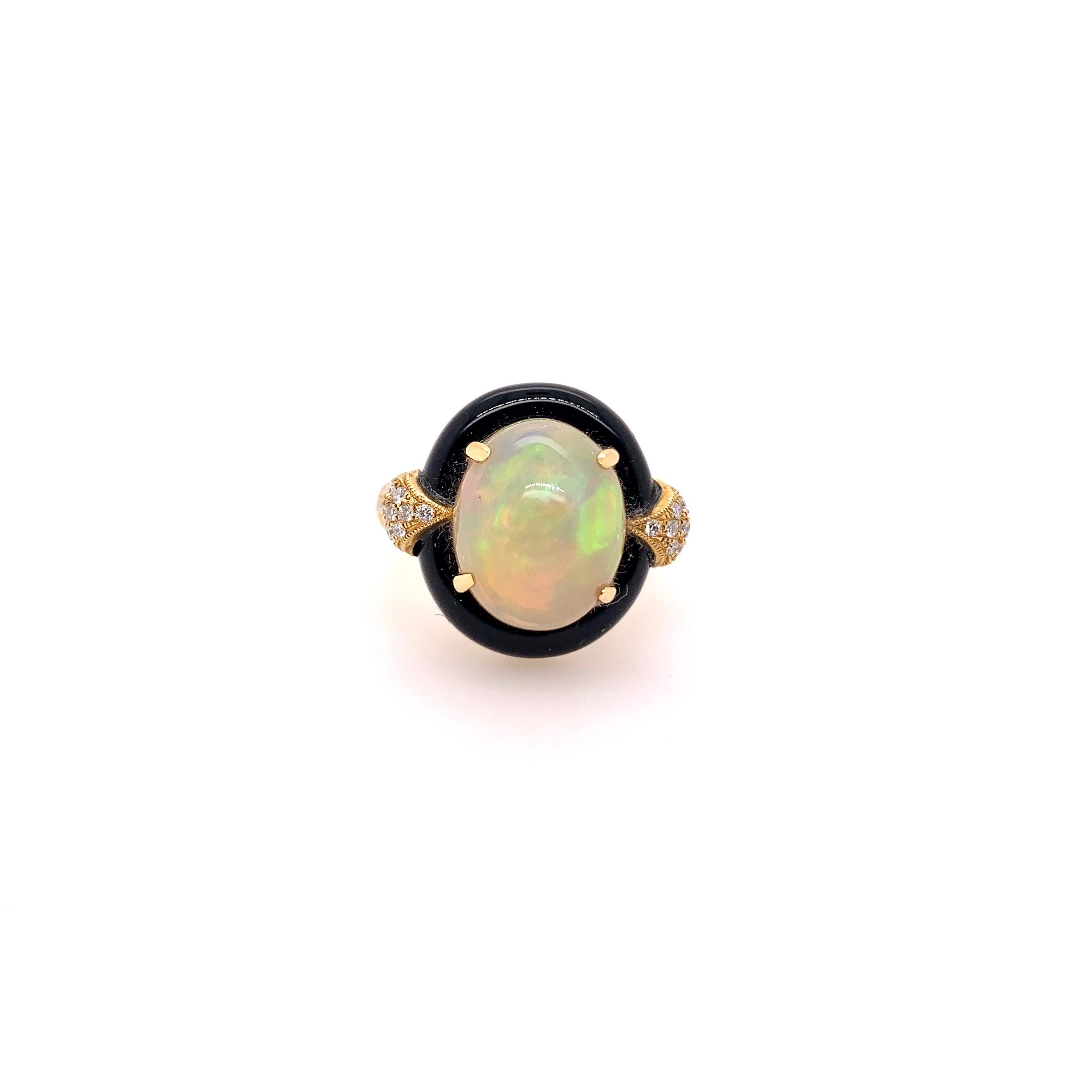 This stunning Ethiopian Opal is set in a custom made setting with special cut onyx to encompass the fiery stone.  The 18k yellow gold setting is further accentuated by the elaborate round brilliant diamonds set in and around the entire top half of