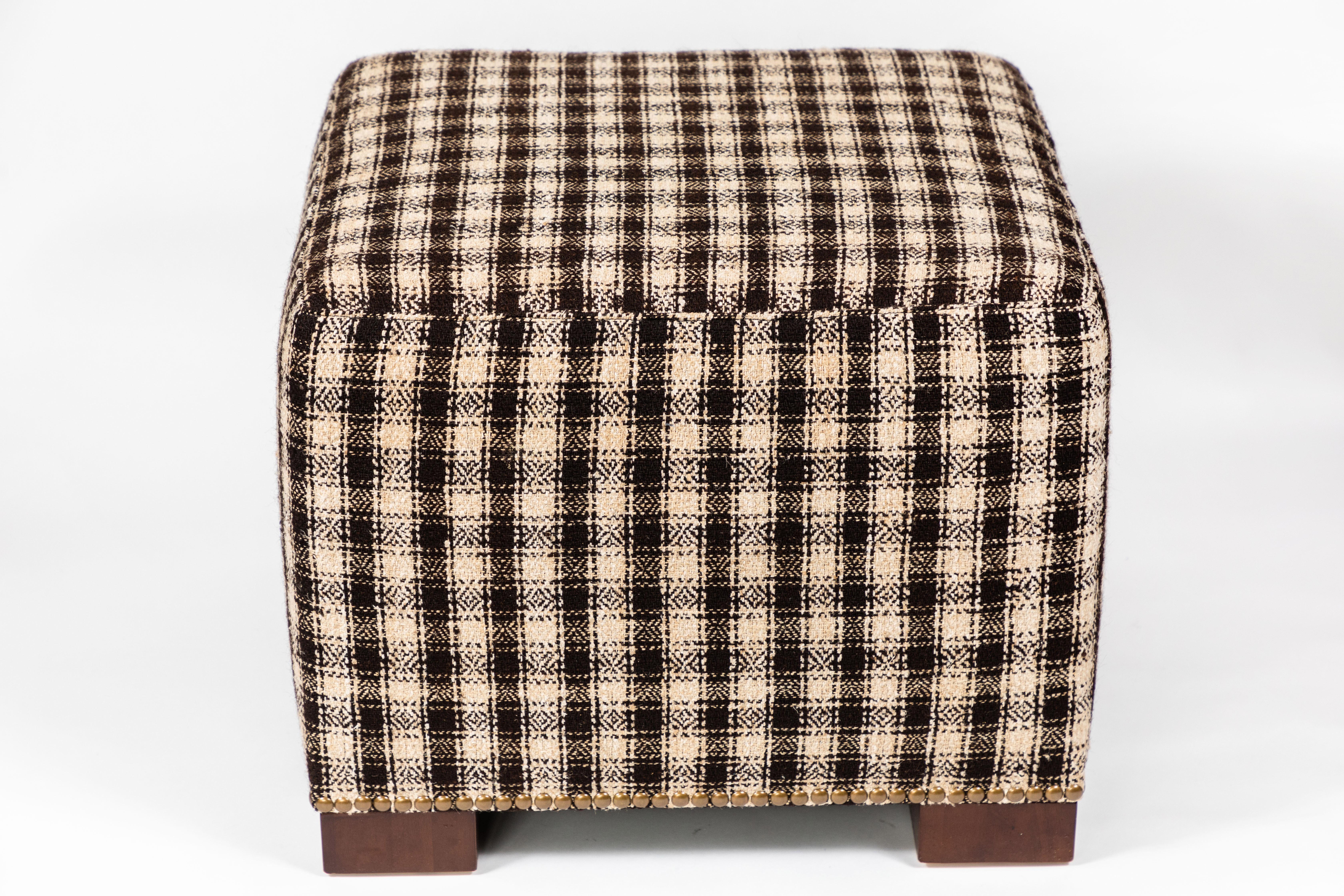 Limited Edition Cubes combine vintage textiles with custom-scaled pieces to create interesting and useful accent seating. Each piece is one of a kind. 

This custom-made ottoman with wood feet and nailhead trim features a Vintage Wool and Hemp Wagon