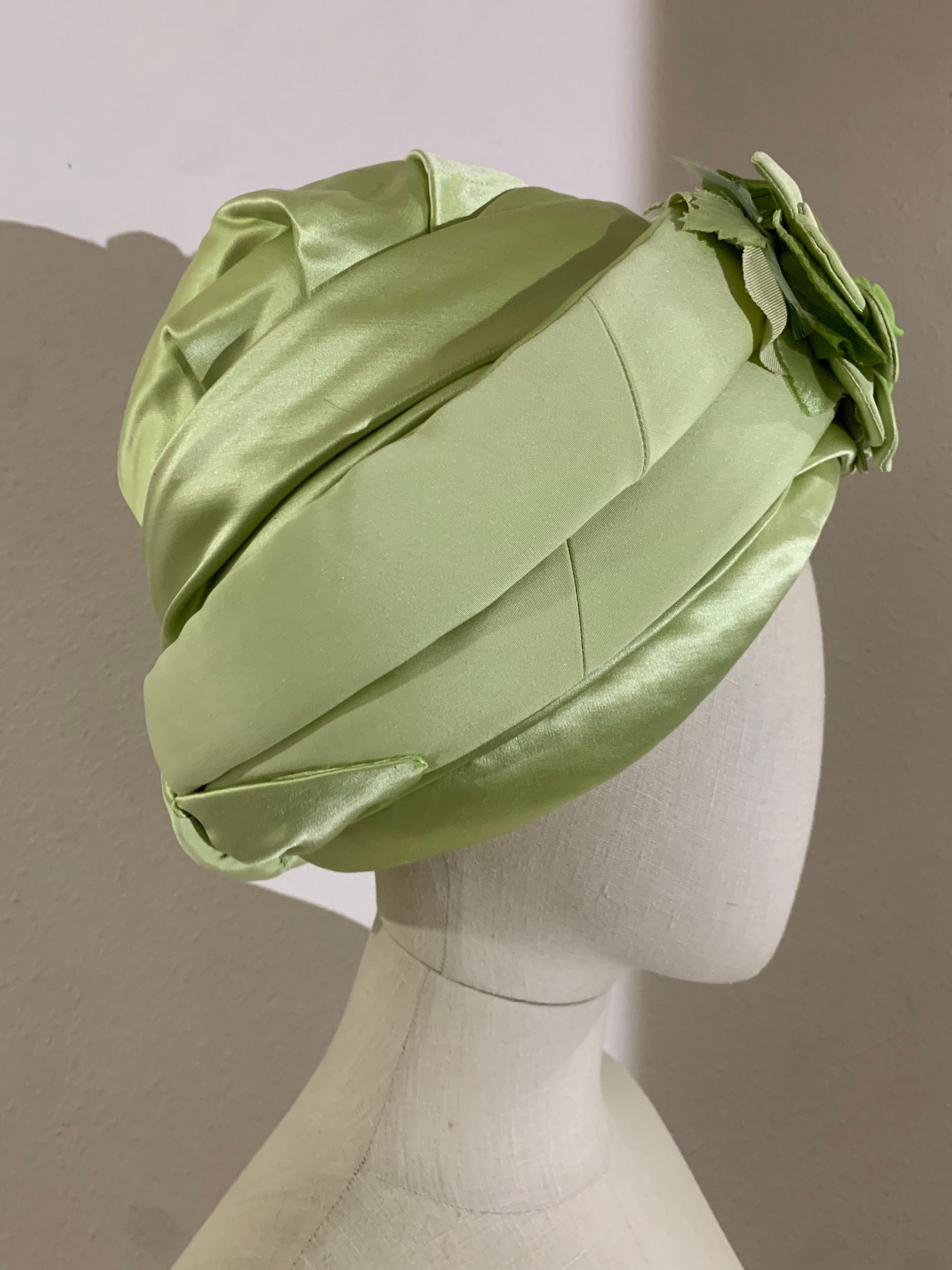 Custom-Made Pastel Green Silk Padded and Wrapped Turban w Center Flower: Fashioned by Suzanne Couture Millinery-NY. Combs inside for securing. Matching hatpin included. Size Med-Large. 

Please visit our 1Dibs Store for many more options from this