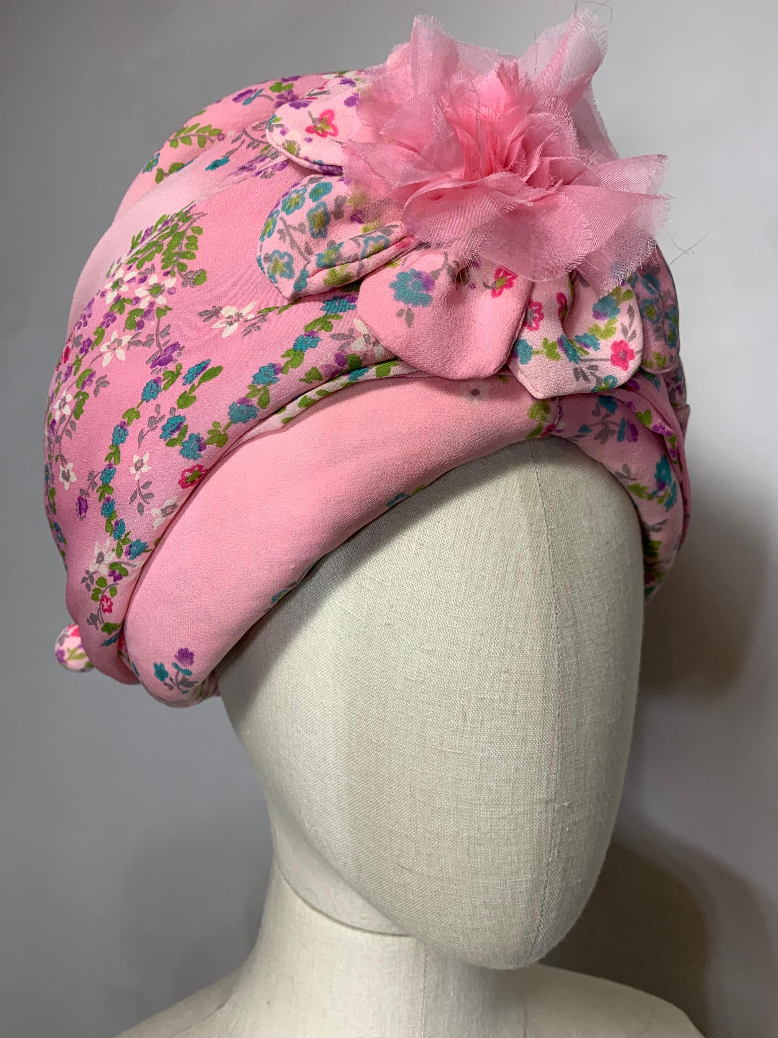 Custom Made Carnation Pink Floral Chiffon Turban w Matching Flower at Front & Hat Pin: Created by Suzanne Couture Millinery. A demure pink floral print on a bold shape, wrapped and draped over a stiffened base for volume. US size 7 1/4. 

Please