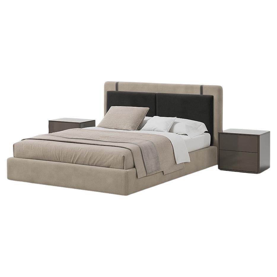 This double bed with a closed base is a commanding centerpiece for any bedroom, its firm lines revealing an architectural language. The continuous base and well-proportioned volumes lend it a stable, serene presence, making it ideal for spaces that