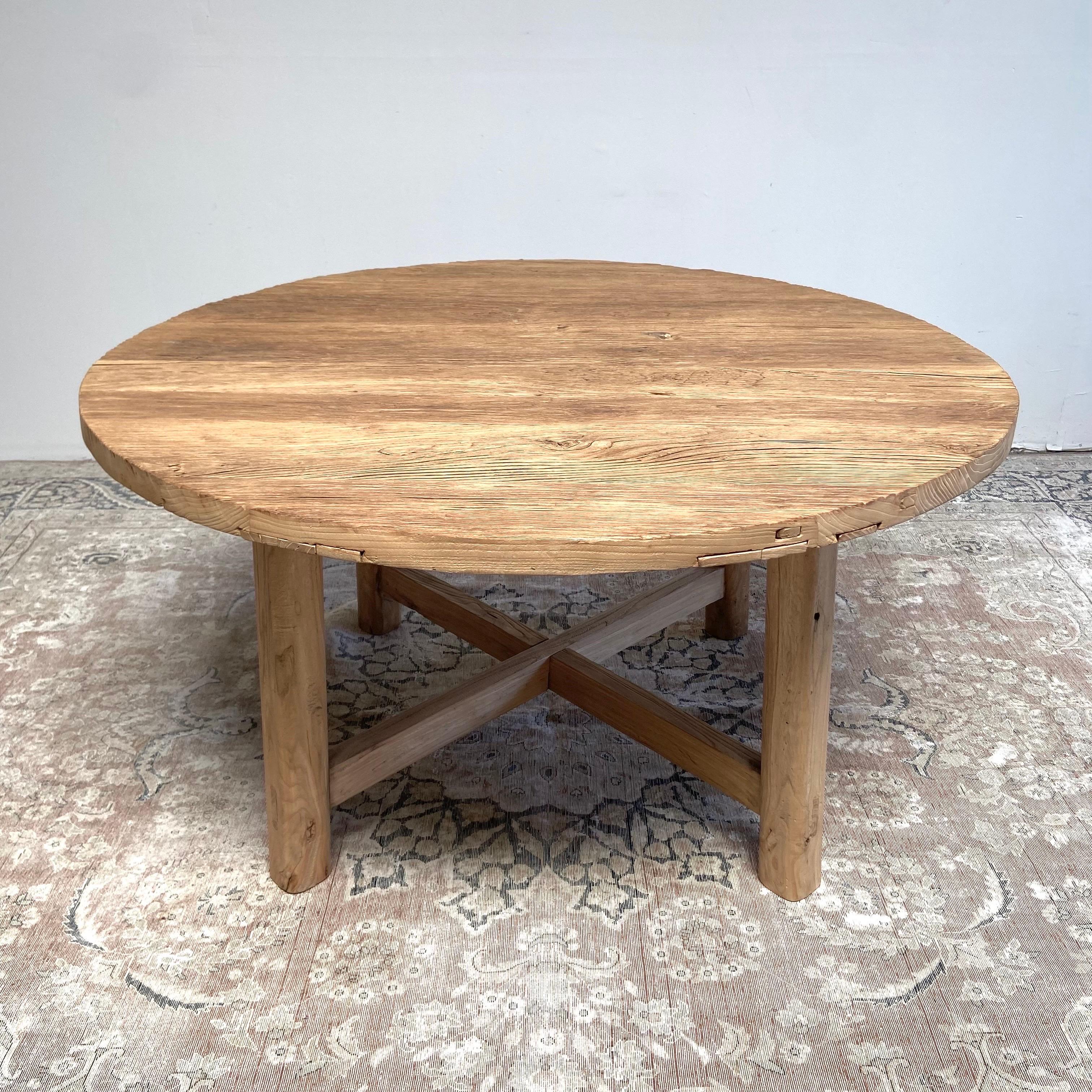 Measures: Round elm dining table 60” rd. x 32” H
( 30” H also available in stock )
Custom made thick top reclaimed elm wood dining table by Bloom Home Inc, in a medium brown finish. 
Table comes in as table top with legs made with dovetail