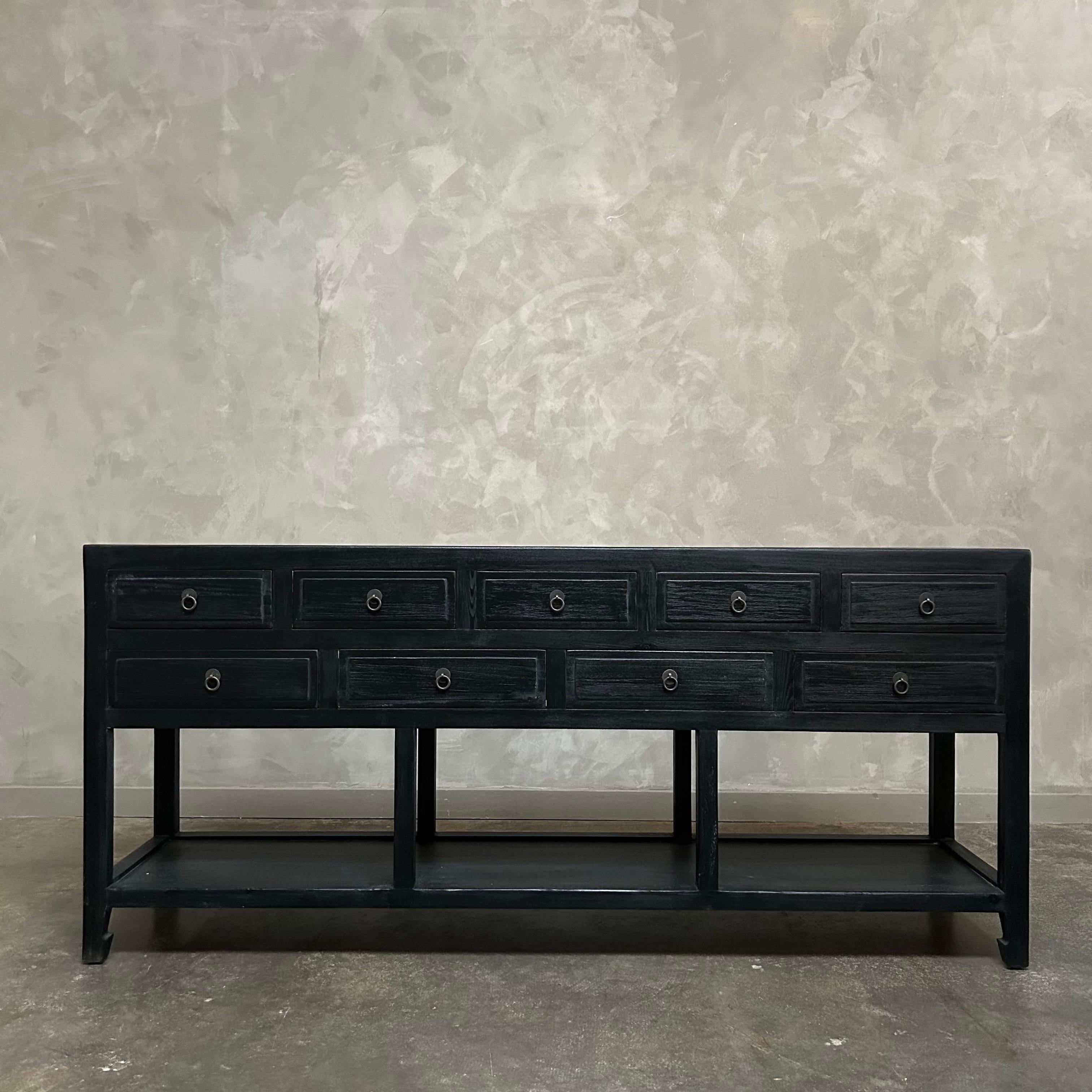 Our custom made console is a perfect blend of style and functionality.  Crafted with reclaimed wood in a black painted finish, this console will add a timeless look to any space.  With its abundance of drawers, it serves as an excellent entry piece