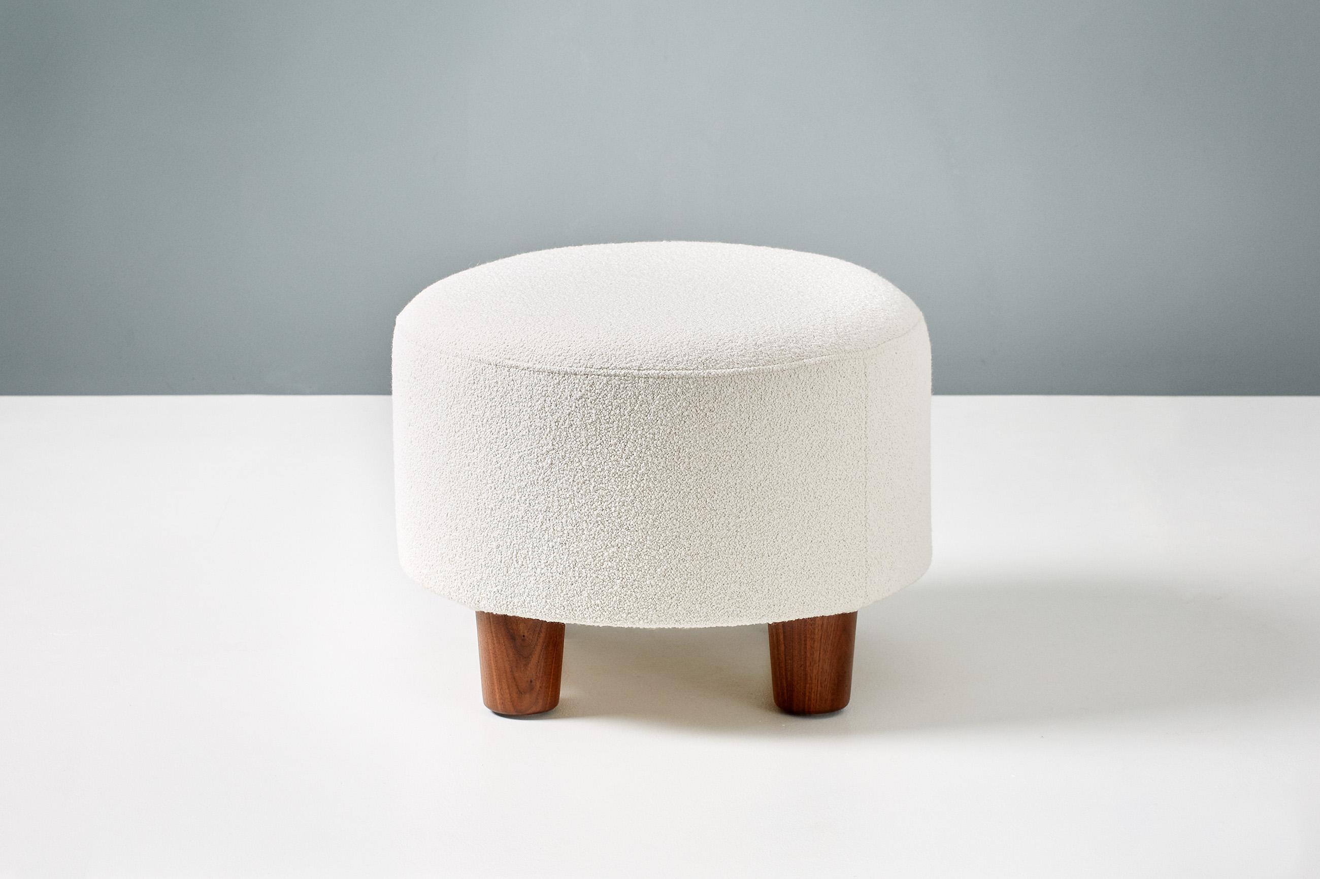 A round, custom made shearling ottoman on hardwood base with oiled walnut legs. The foam body is covered in premium, cotton-wool blend boucle fabric. 

These items are made to order in our London workshop, multiple pieces are available by request.