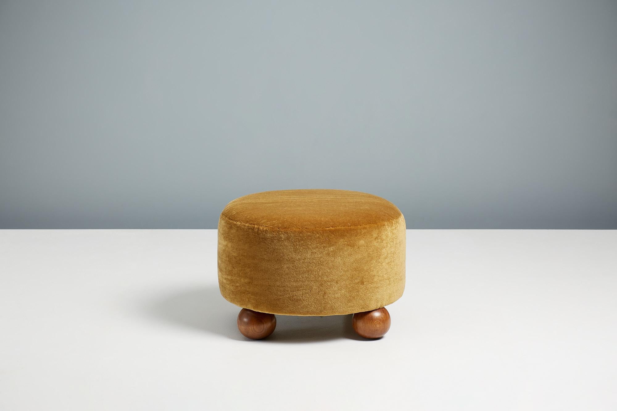 Dagmar - Luupo Round Ottoman

Custom-made ottoman developed & produced at our workshops in London using the highest quality materials. This examples are upholstered in a mustard mohair velvet by Pierre Frey with fumed oak ball feet. This ottoman is