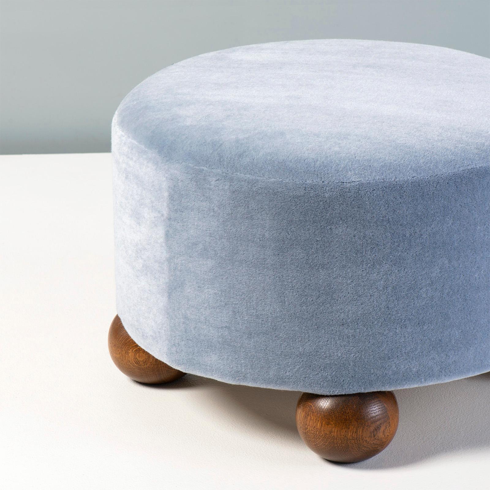 Dagmar - Luupo Round Ottoman

Custom-made ottoman developed & produced at our workshops in London using the highest quality materials. This example is upholstered in a sky blue mohair velvet by Pierre Frey with fumed oak ball feet. This ottoman is