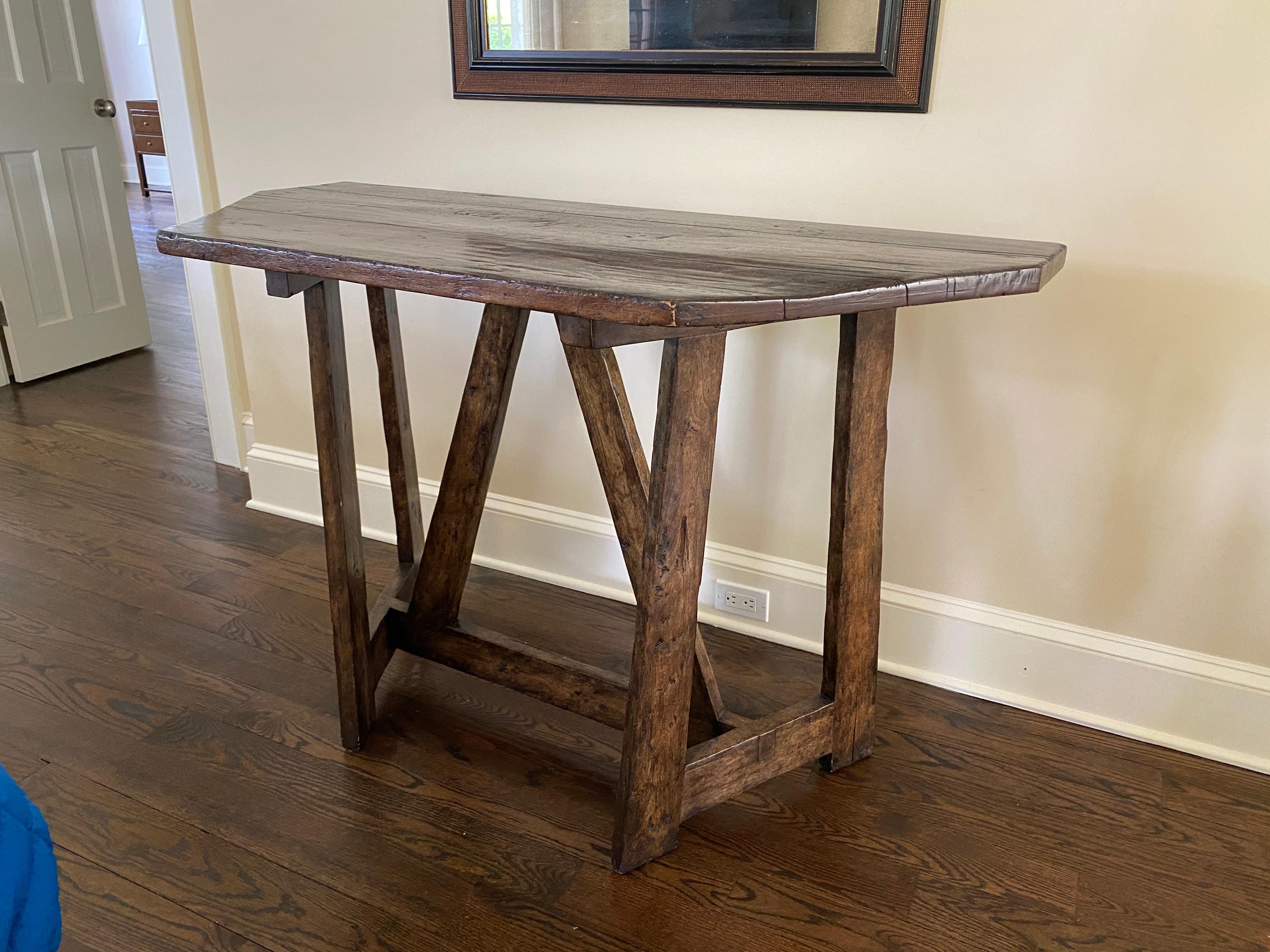 Custom made rustic console table, 21st century
H-Stretcher Base with angled supports, adding interest to the design. A newer table made to look older. Two consoles available. Some light wear and chips to finish on edges, shown in photos. Good
