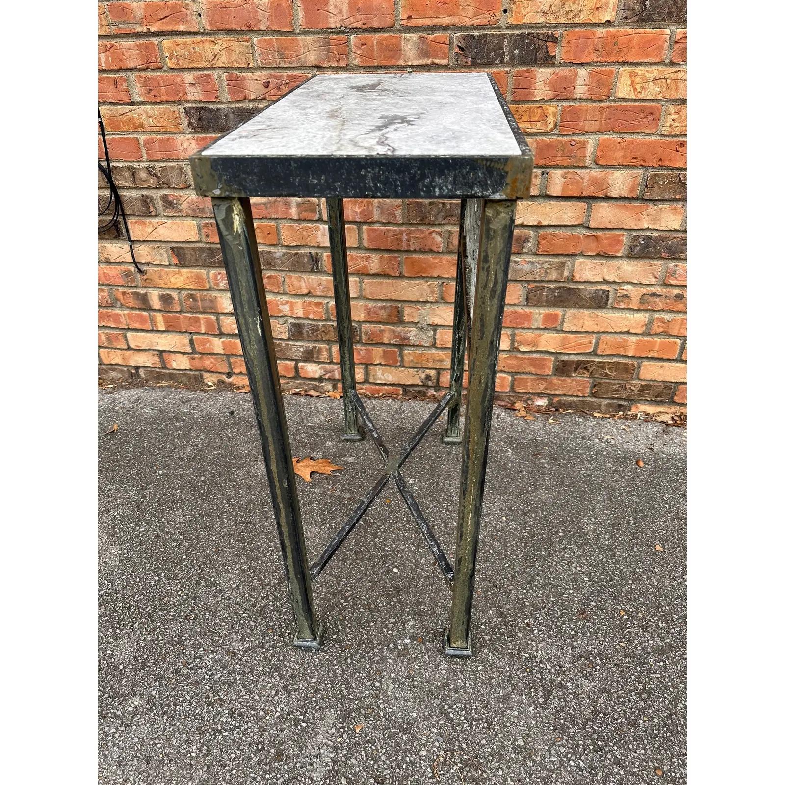 This is a beautiful little iron side table! Custom made following an antique French style. The iron has a distressed finish, with gray running along the legs matching the ornamental paisley design of the front and focal point of the piece. The top
