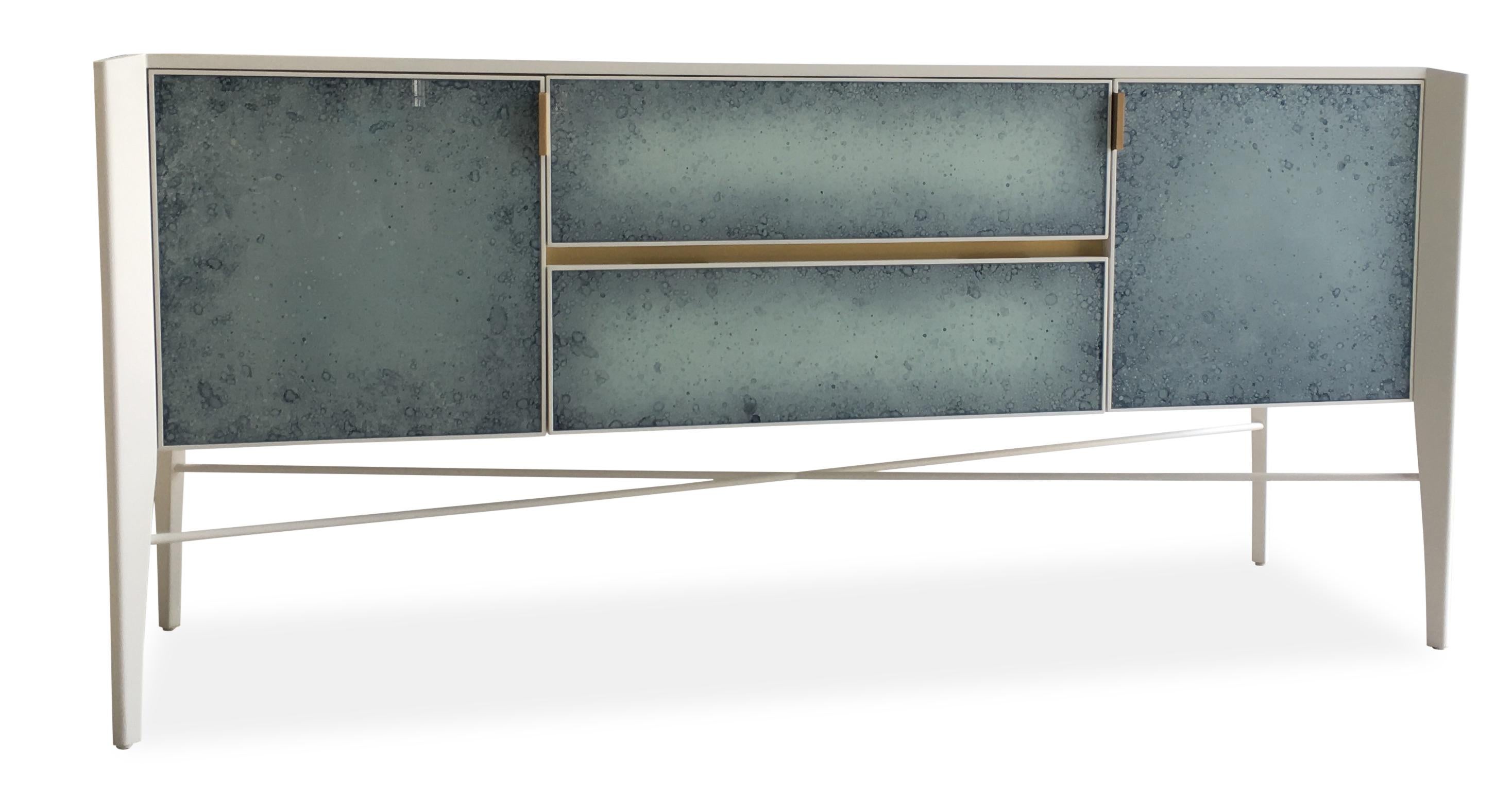 This custom made sideboard is made in a high gloss finish of the top of an American oak frame. 

Solid custom made hardware combined with antique glass door and draw fronts which has a blue coloring added to the finishing process to give the