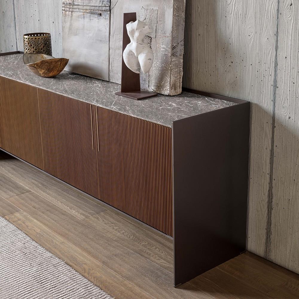 This piece showcases an exquisite design that highlights the expressiveness of its materials. The four doors are crafted from American walnut (Canaletto) canneté and feature a push-back opening system for a sleek, handle-free look. Inside, the
