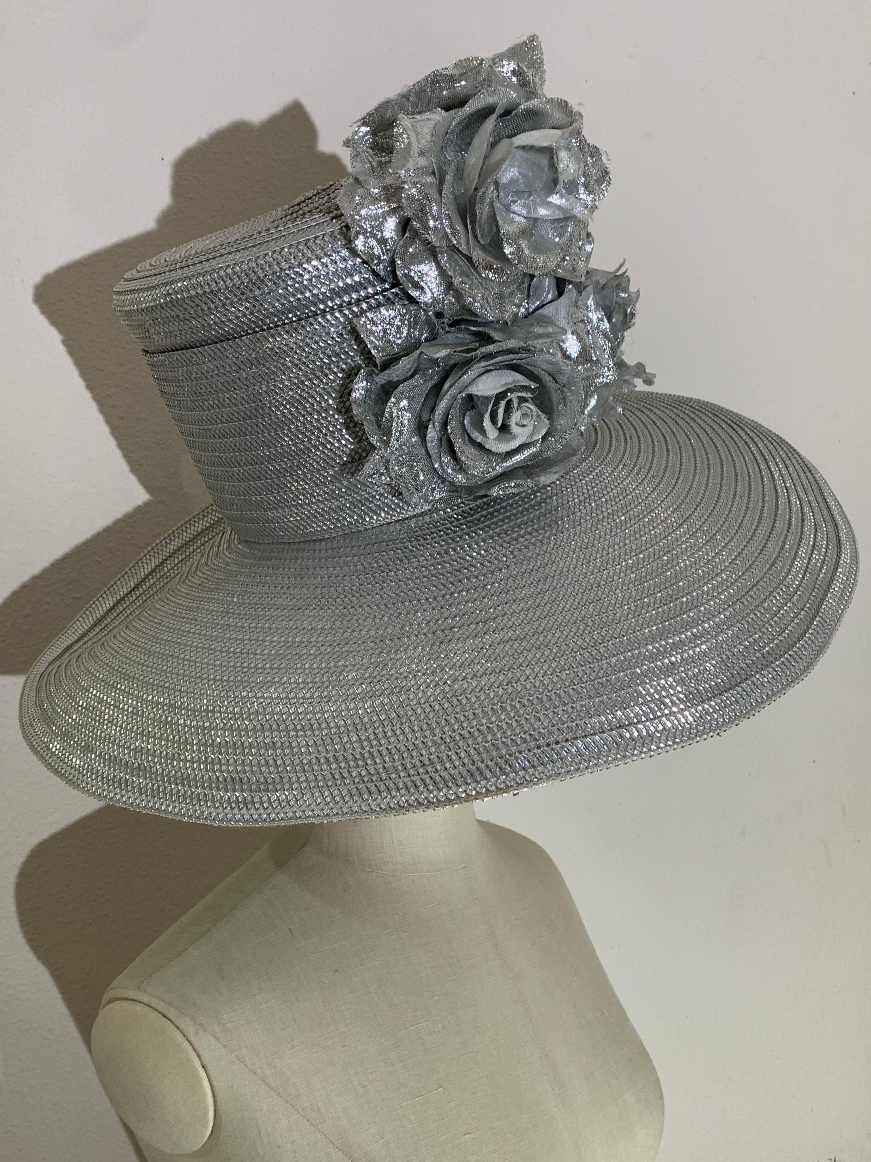 Custom Made Silver Lamé Ultra-Wide Brim Cartwheel Hat w/ Silver Floral Bouquet:  A real head-turner in glitzy silver metallic lamé straw, this Suzanne Couture Millinery Hat was made for the spotlight with a huge brim, tall crown and a huge bouquet