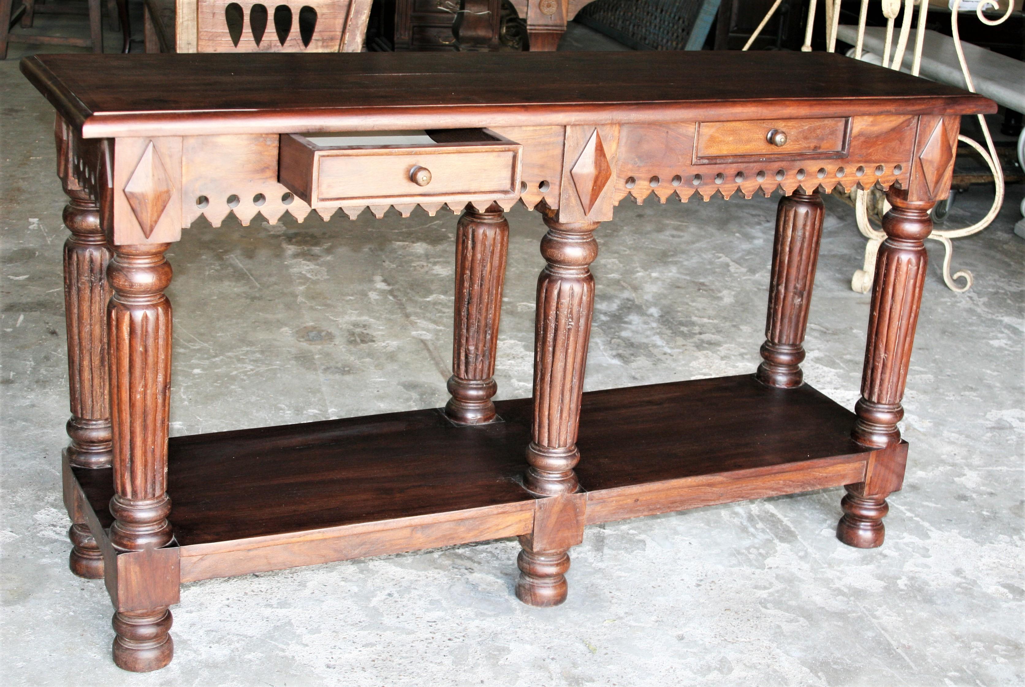 The design for this beautiful console table was influenced by the styles used in England. Very fine teak is used and typical of all furniture made in Asia at the time for European settlers, the table is heavily made using old world carpentry. It was