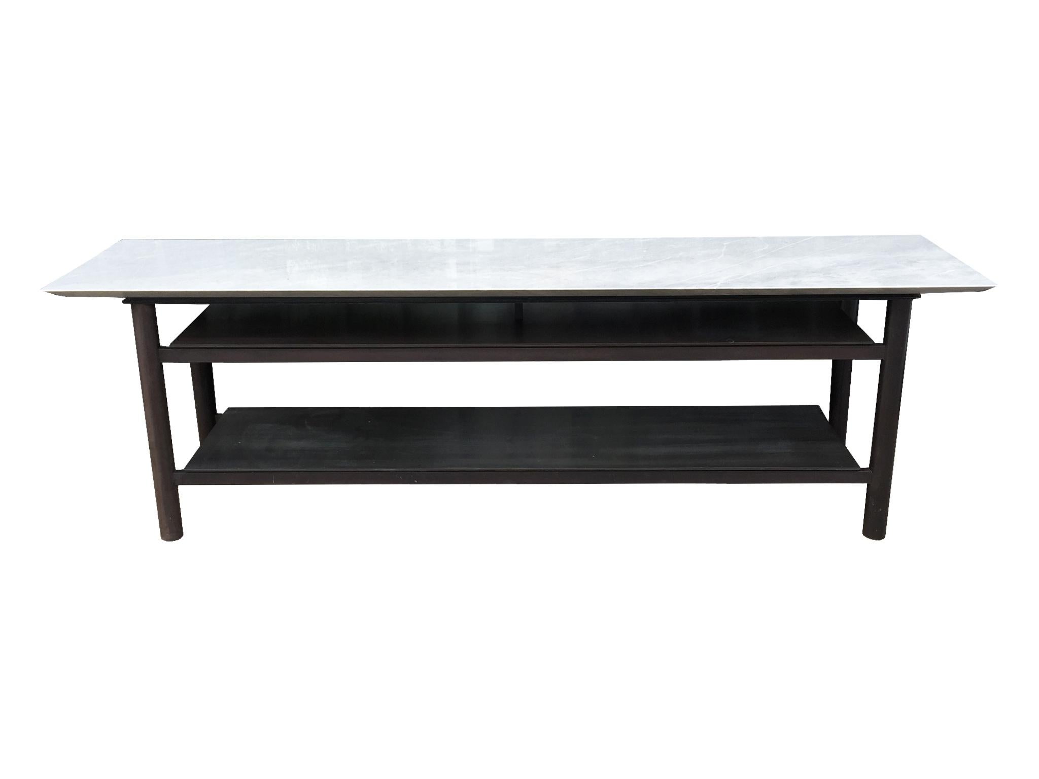 This exceptional sofa table is custom made. It's comprised of a steel base and white marble tabletop. Cut with clean, smooth lines, the table is a substantial piece of furniture, an ideal stably grounded surface that can be placed behind a sofa or