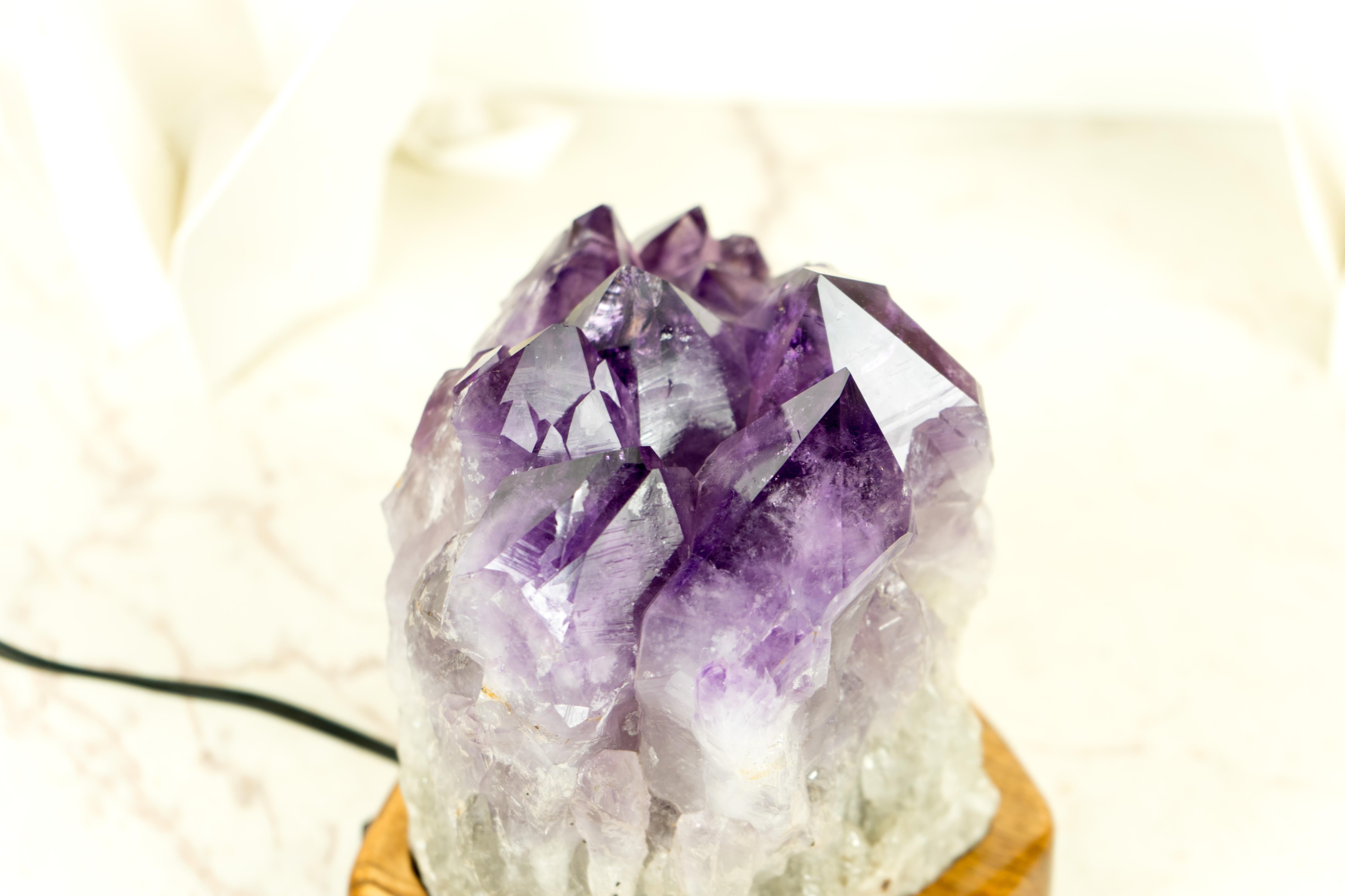Designed by E2D Crystals, this Amethyst table lamp is an exquisite piece of decor. Created with a focus on uniqueness, quality, and beauty, this lamp showcases both natural artwork and skilled craftsmanship. 

The lamp was designed to blend the